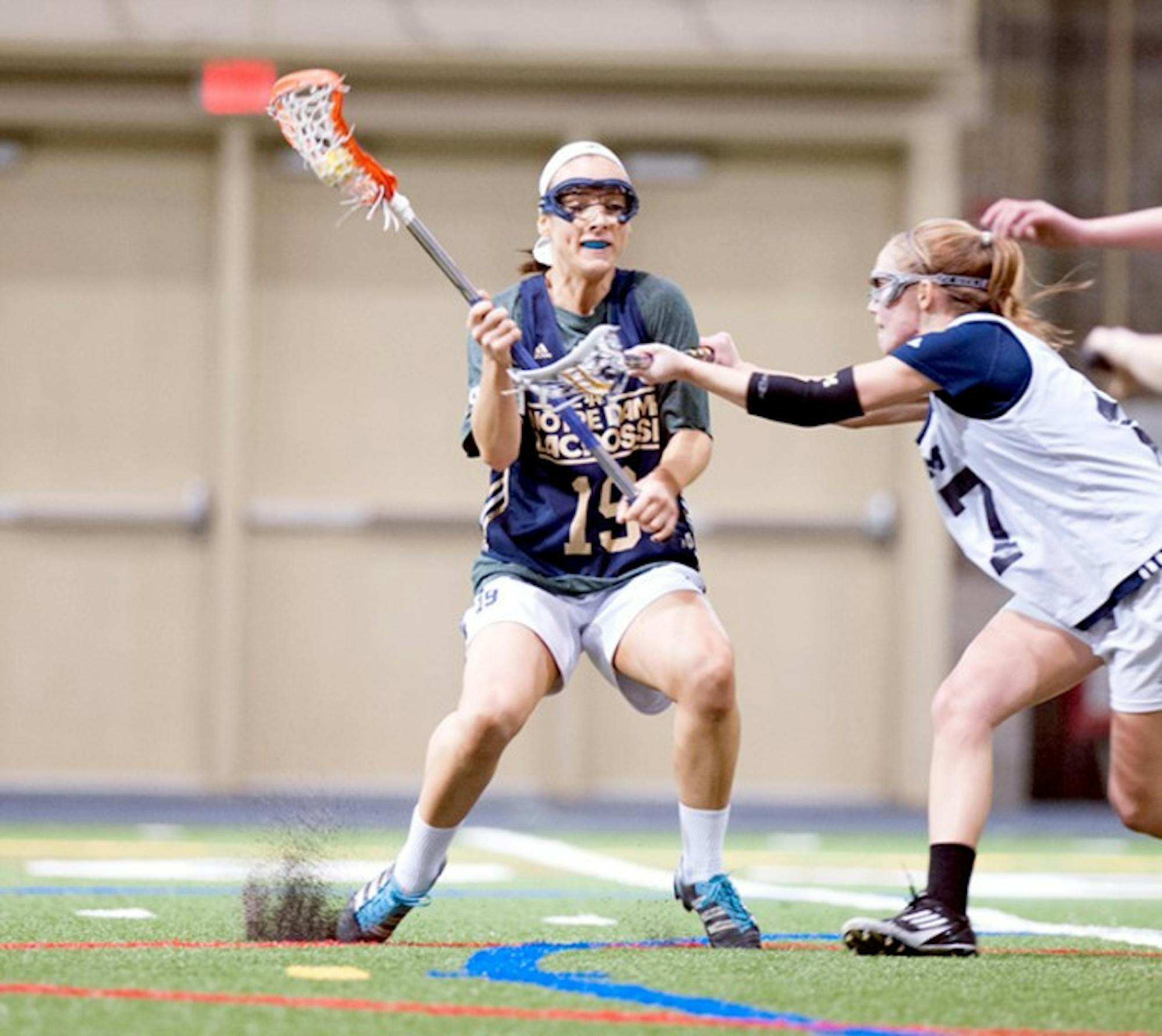 Irish senior midfield Julia Giorgia dodges a Michigan player during Notre Dame’s 19-7 victory over the Wolverines on Feb. 8. The Irish, coming off of two straight losses, will take on Duke on Friday at Arlotta Stadium at 7 p.m.