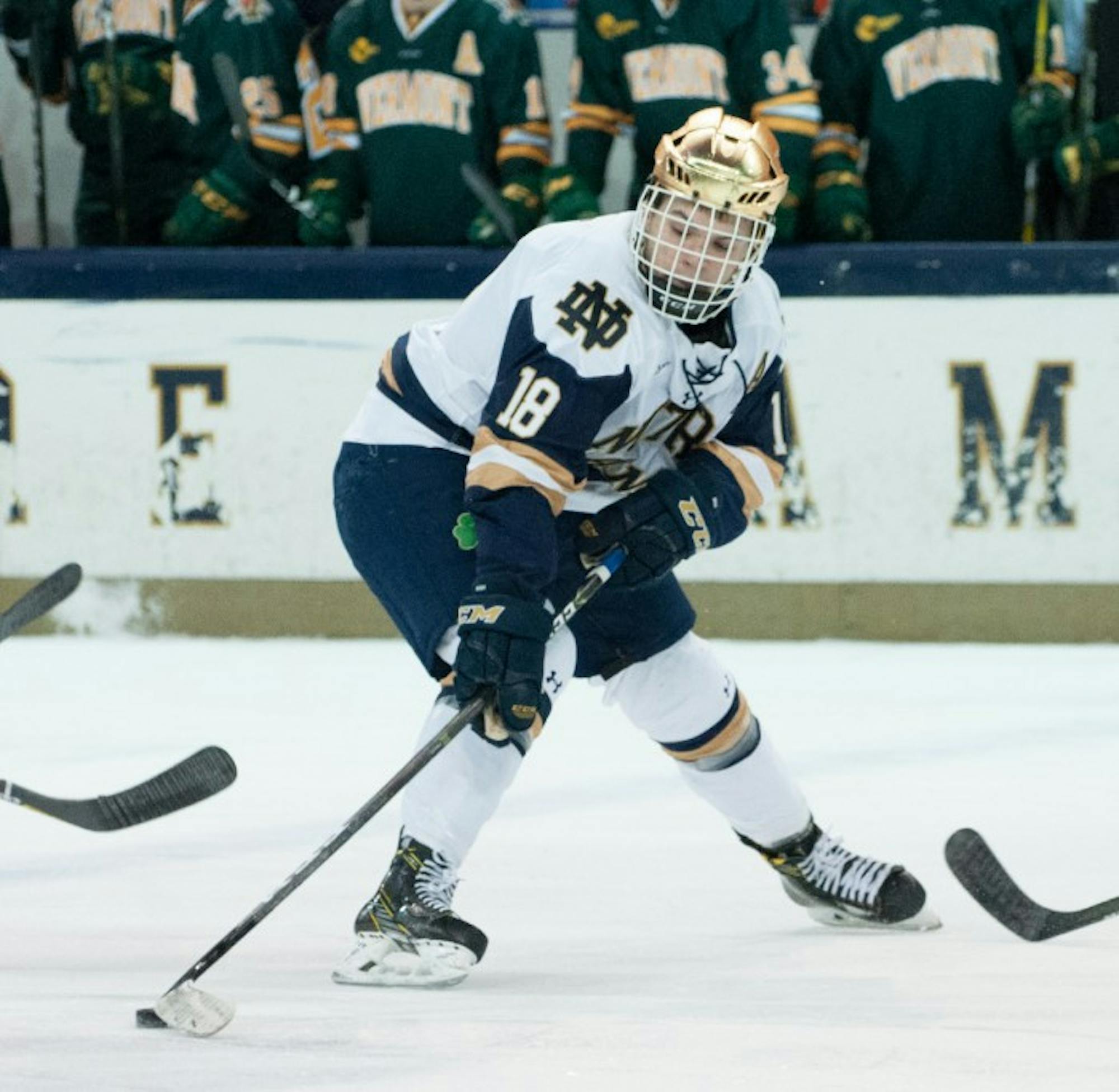Irish junior forward Jake Evans maneuvers the puck in Notre Dame’s 4-4 tie with Vermont on Feb. 3 at Compton Family Ice Arena.