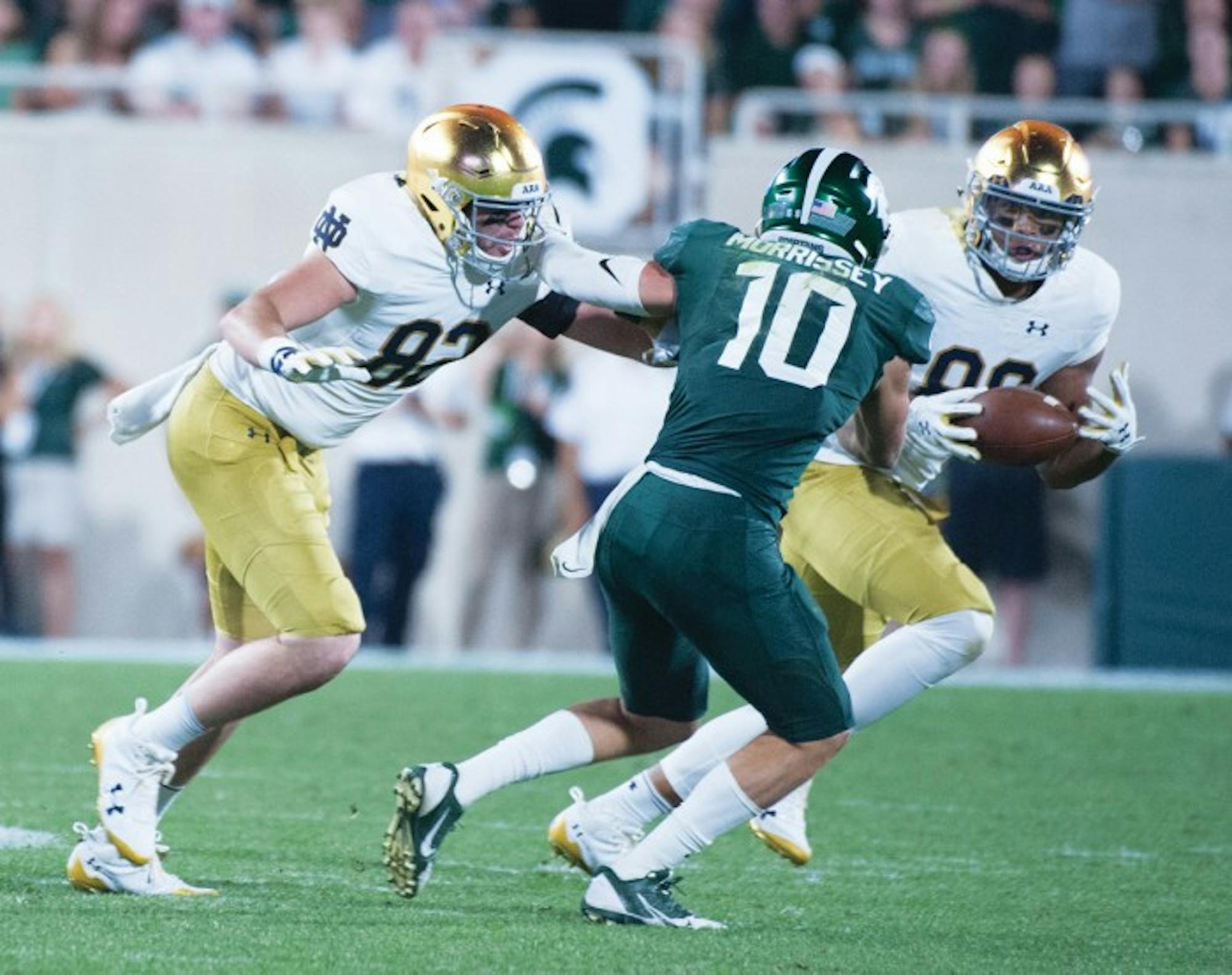 Irish junior tight end Alize Mack dodges a defender during Notre Dame's 38-18 win over Michigan State on Saturday in East Lansing, Michigan.