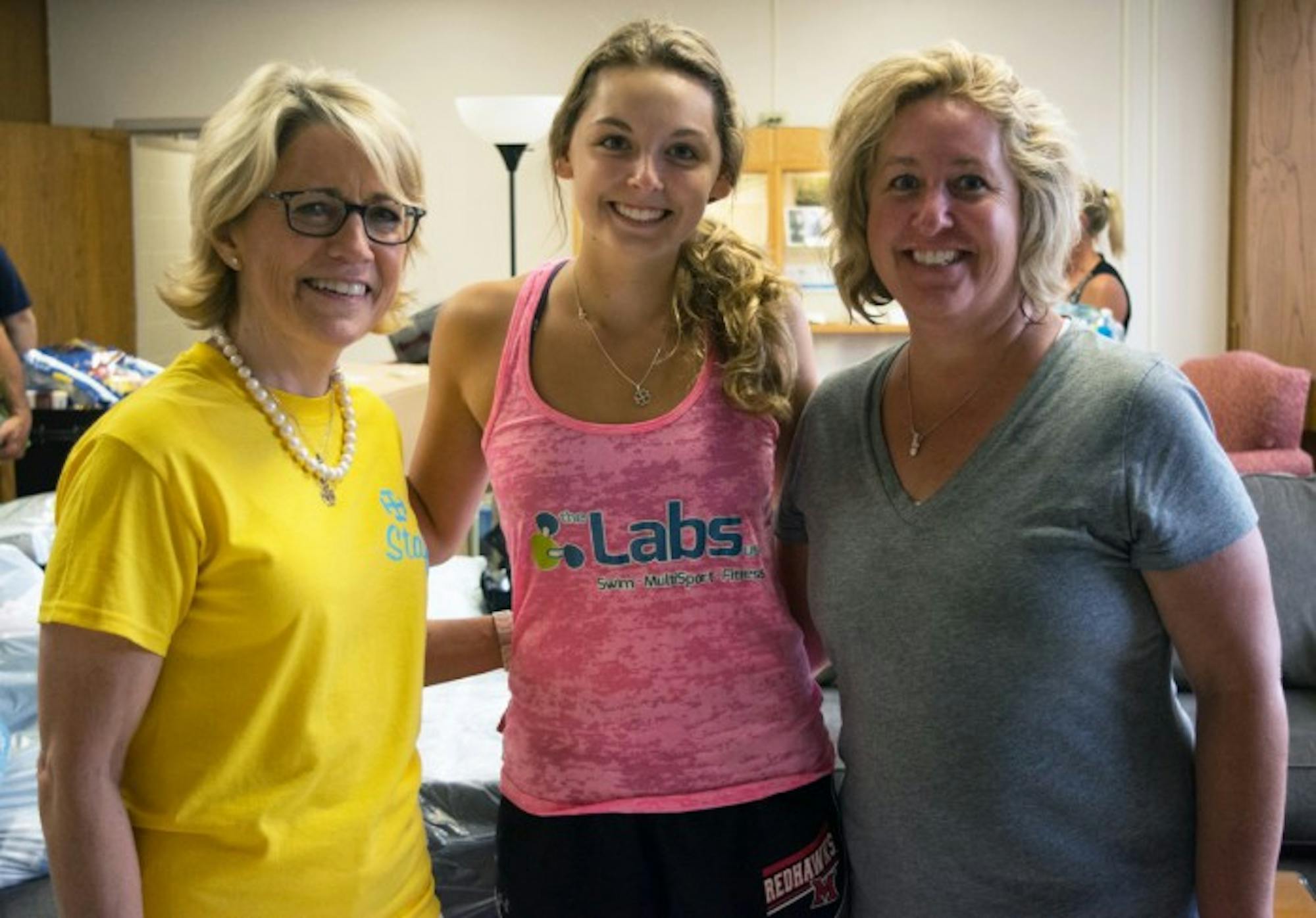Saint Mary’s president Jan Cervelli (left) welcomes first-year Olivia Propheter and her mom as they move into McCandless Hall.