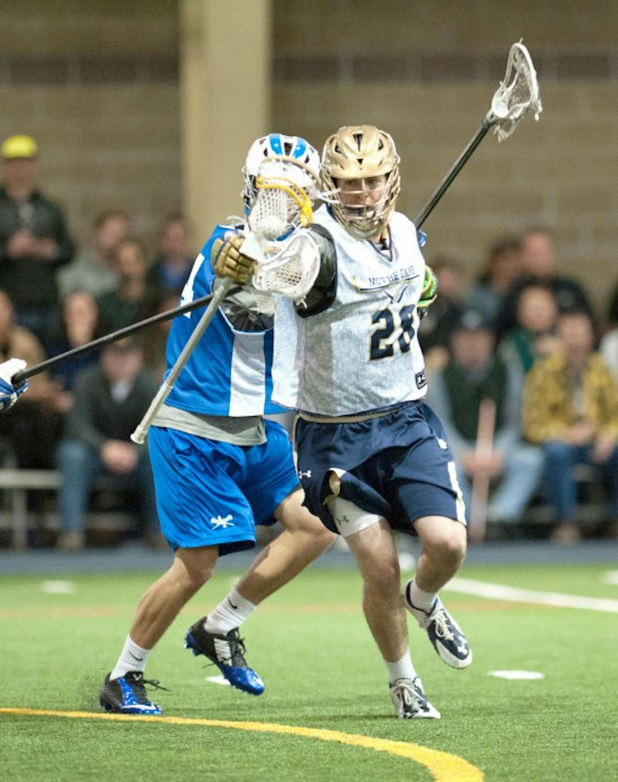 Irish senior attack Conor Doyle slips away from an Air Force defender during the two teams’ exhibition Jan. 31.