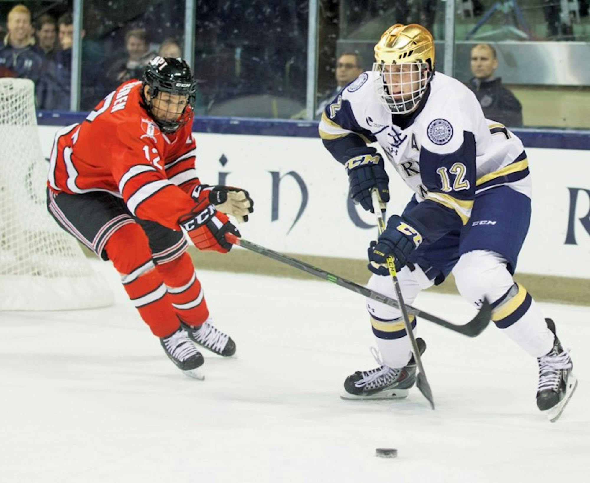 Irish junior left wing Sam Herr tries to sneak past a Rensselaer defender during Notre Dame’s 3-2 loss to the Engineers on Friday.