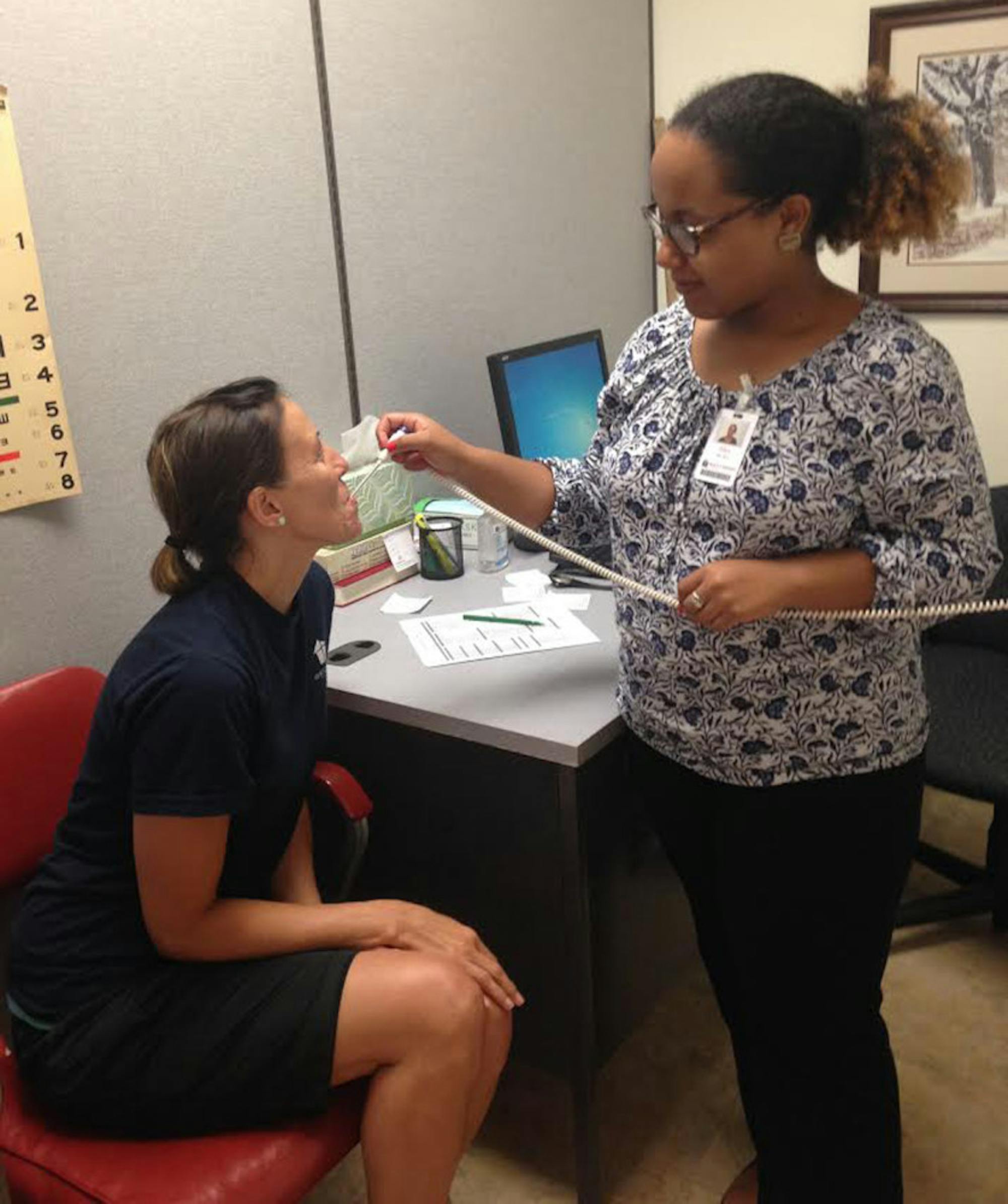Senior Alexandra Rice treats a patient at the Roanoke Rescue Mission's G. Wayne Fralin Free Clinic for the Homeless.