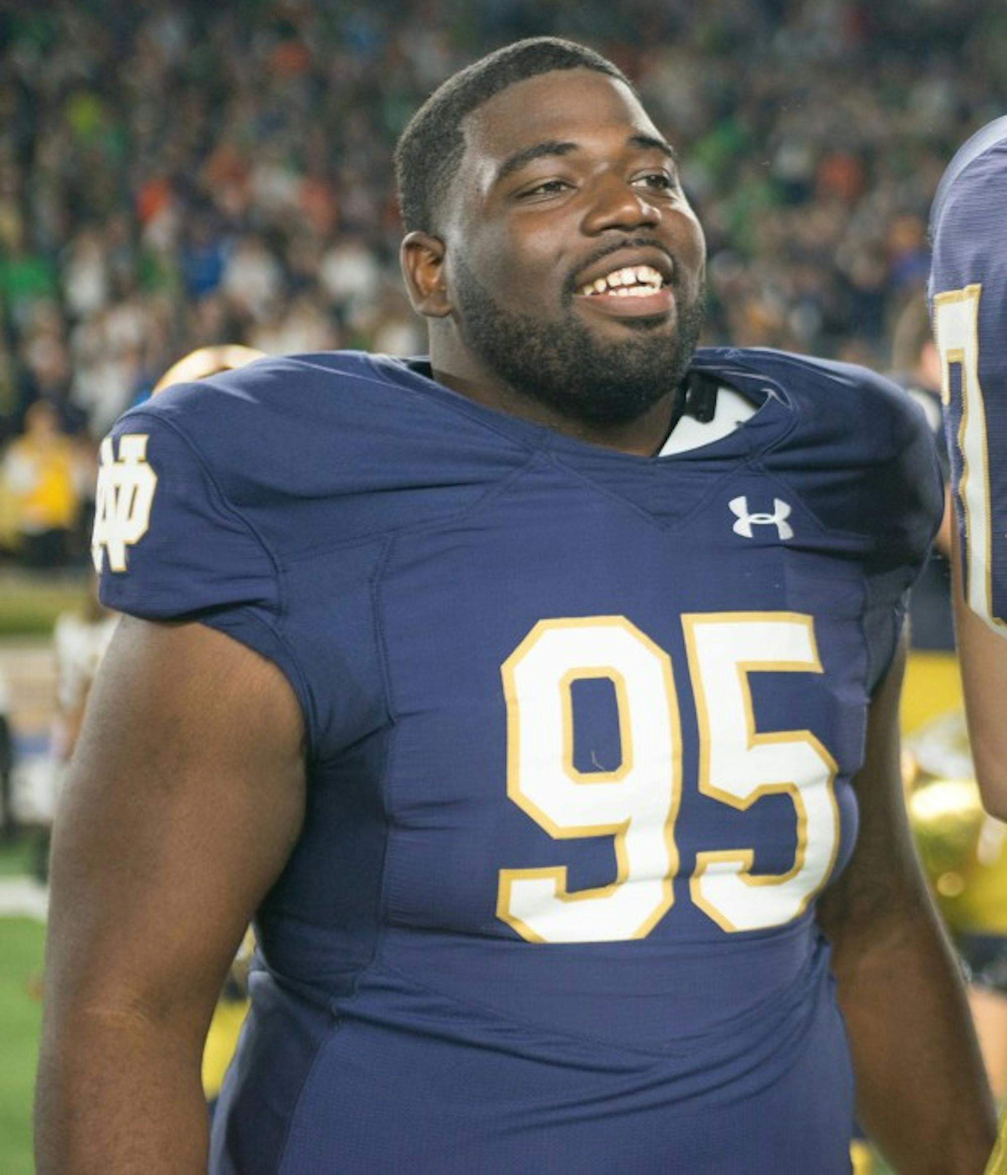 Irish senior defensive lineman Marquis Dickerson smiles while the team lines up for the Alma Mater after Notre Dame beat Miami.