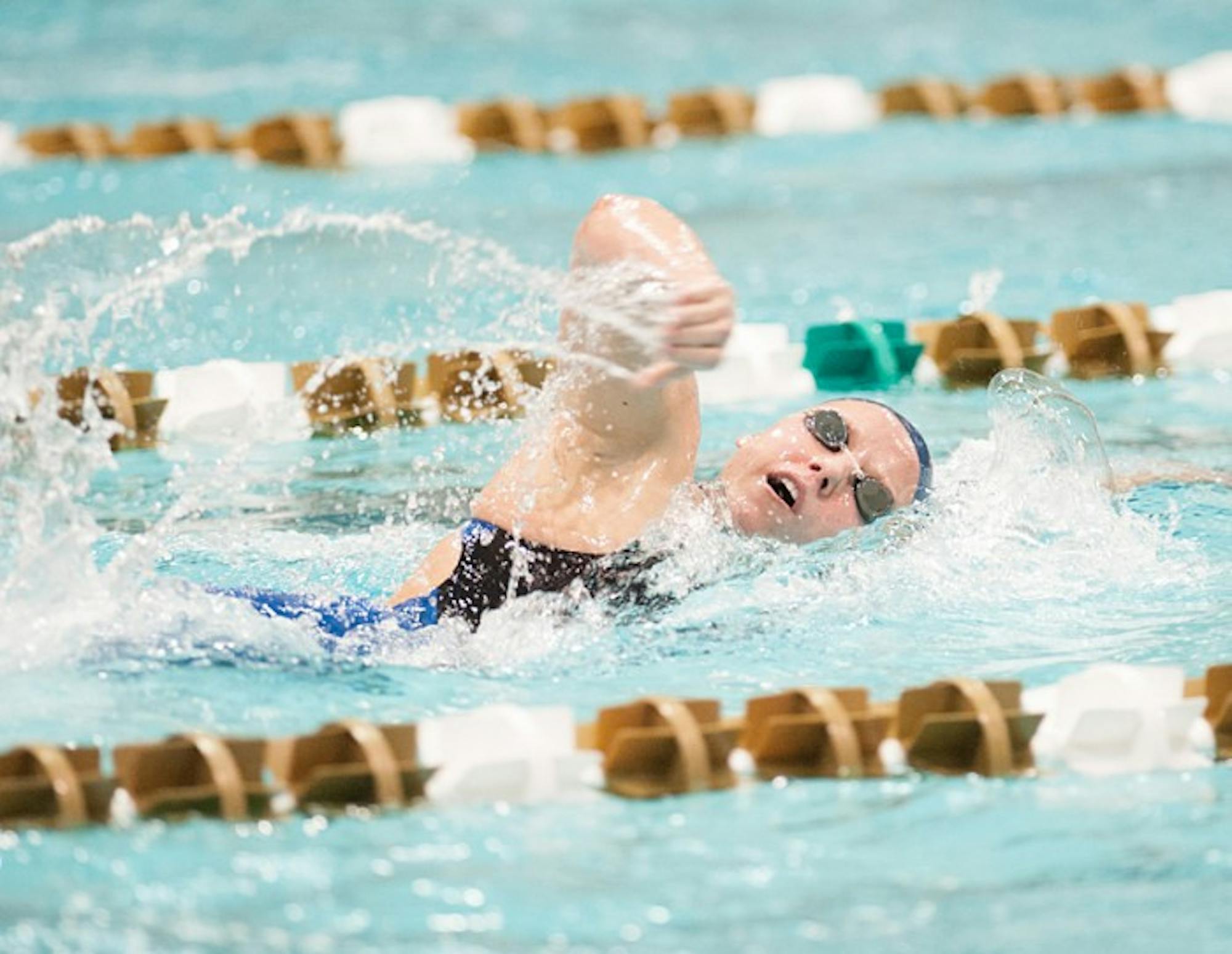 Junior Emma Reaney swims the freestyle segment of the 200-yard individual medley at the Shamrock Invitational against Iowa on Friday. Reaney broke a Rolfs Aquatic Center record in that swim.