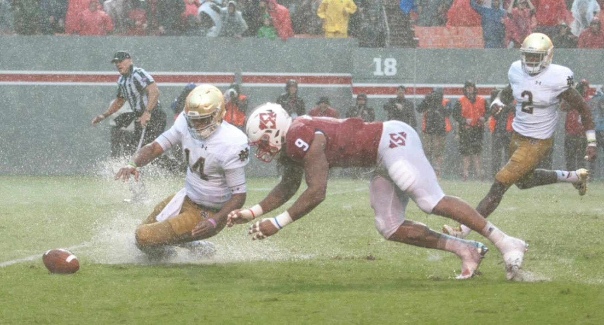 Irish junior quarterback DeShone Kizer and N.C. State junior defensive end Bradley Chubb dive for the loose ball after a miscommunication between Kizer and junior center Sam Mustipher. Kizer recovered the loose football.