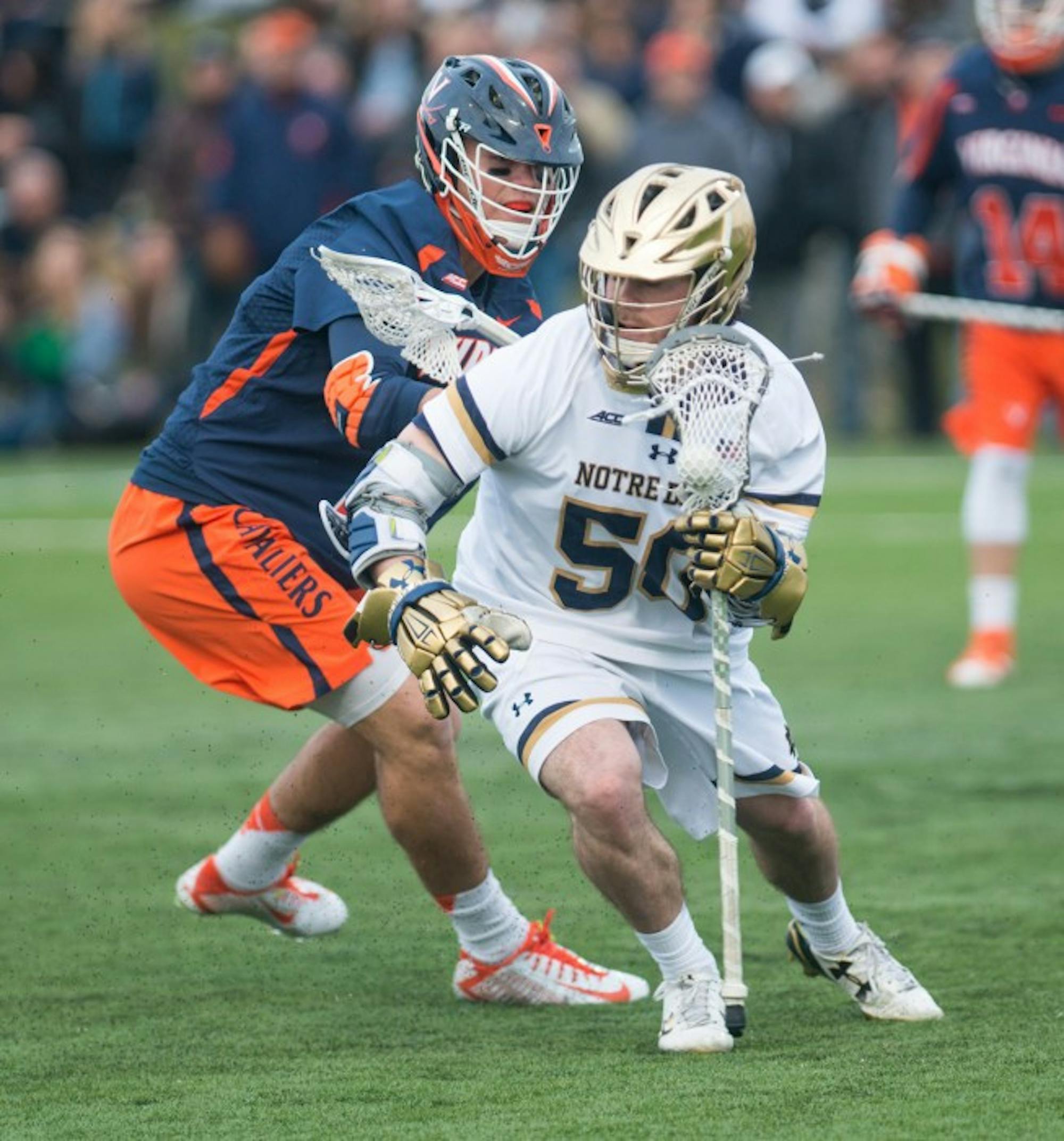Senior attack Matt Kavanagh shields a defender during Notre Dame’s  8-7 overtime victory over Virginia on March 19 at Arlotta Stadium.