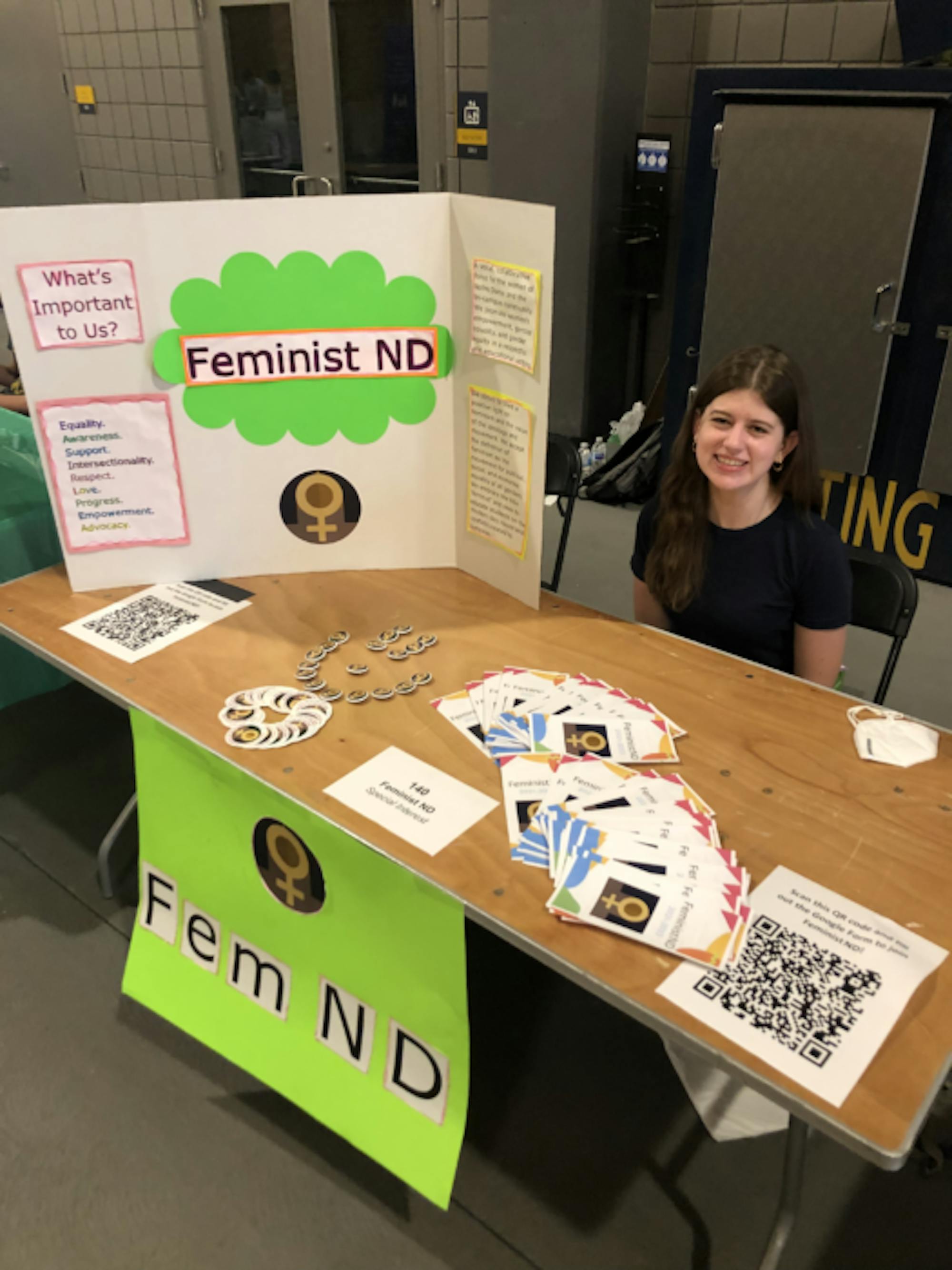 Julianne Downing sits at the Feminist ND booth during ht e activities fair in Fall of 2021.