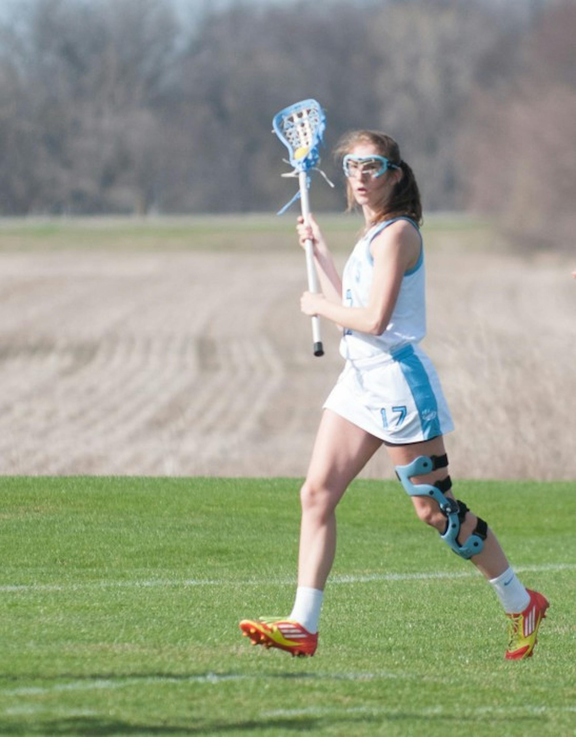 Belles sophomore attack Emilie Vanneste looks to move the ball during a 19-4 setback against Calvin on April 15.