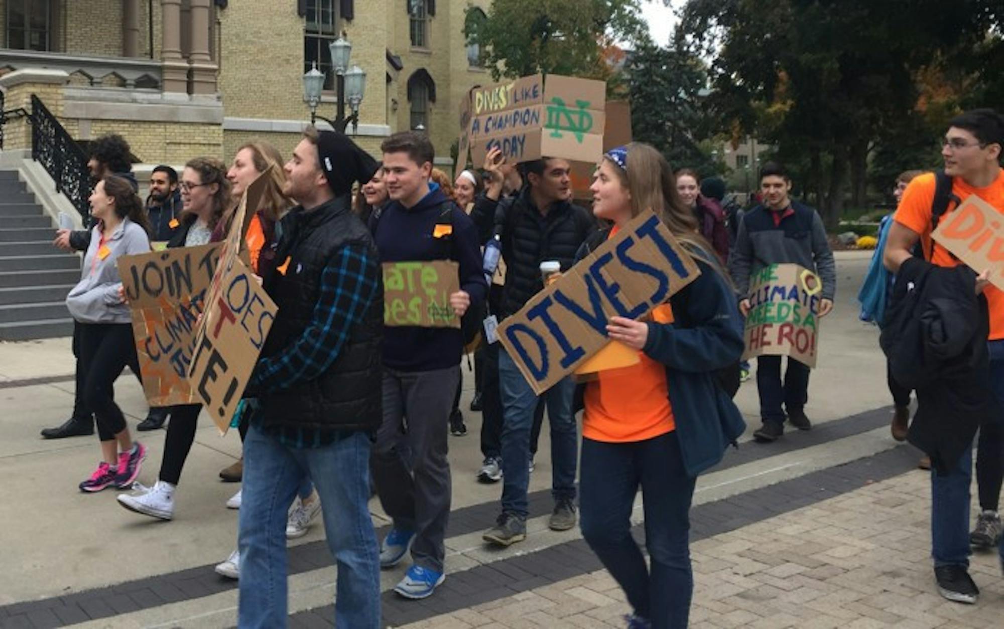 Led by sophomore Adam Wiechman, students in Fossil Free ND march in protest to the Dome.