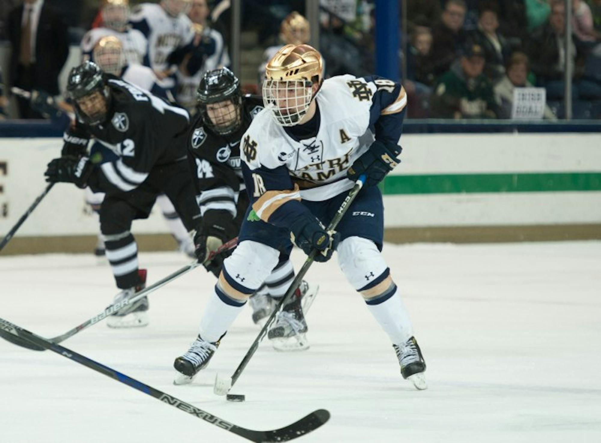 Irish senior forward Jake Evans carries the puck up the ice during Notre Dame’s 5-2 win over Providence on March 11.