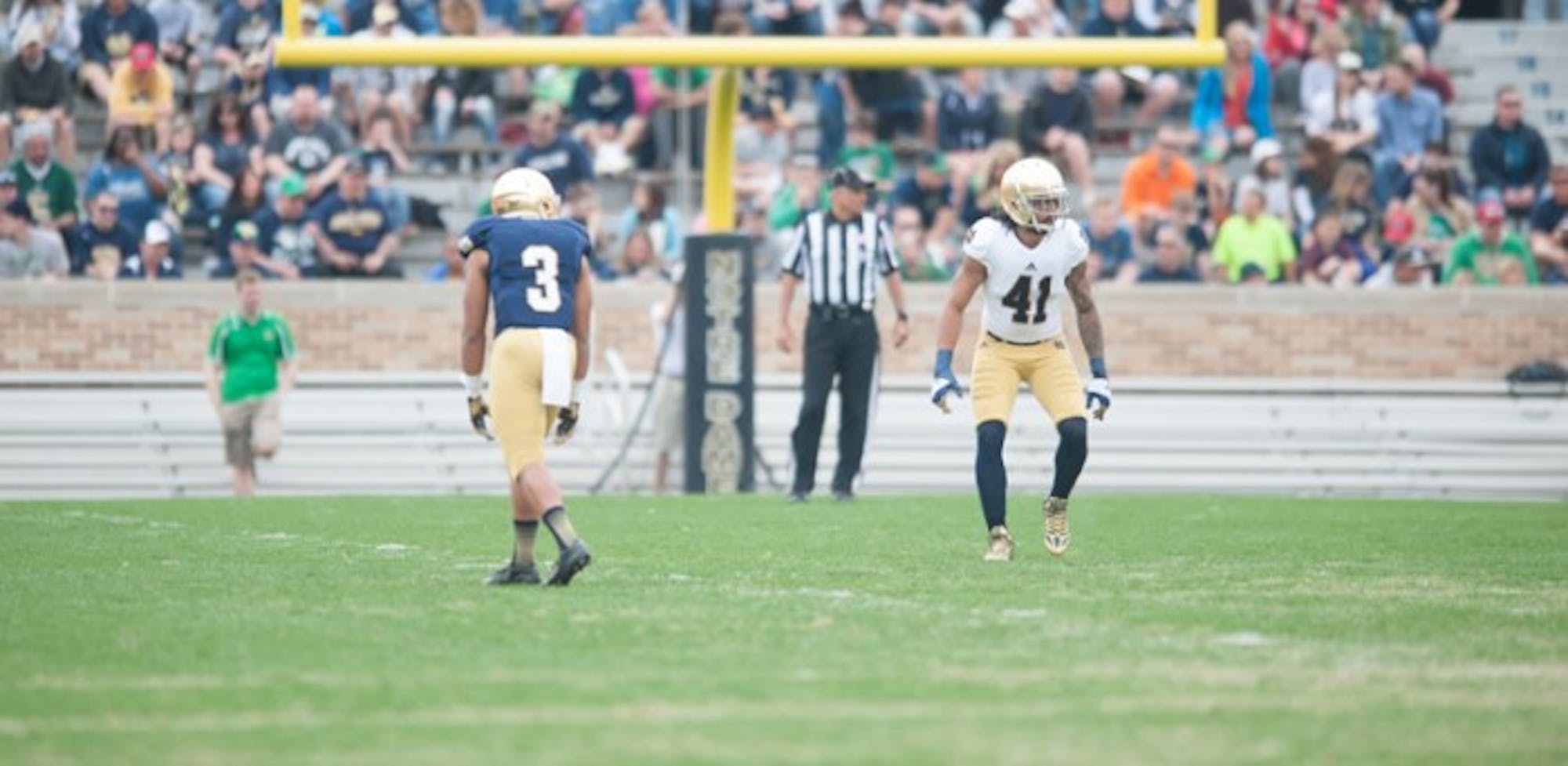 Senior receiver Amir Carlisle, left, lines up against senior cornerback Matthias Farley during the Blue-Gold Game on Saturday. With the announcement that a synthetic playing surface will be installed before the 2014 season, the spring game was the last time the Irish will play on a natural grass field at Notre Dame Stadium.