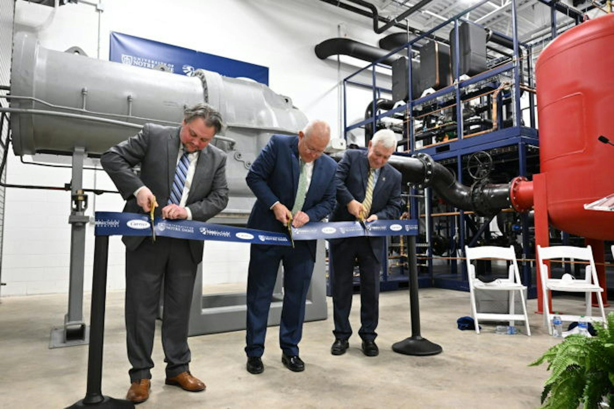 From left to right: Joshua Cameron, director of the Notre Dame Turbomachinery Laboratory, Chris Kmetz, senior vice president, engineering, for Carrier and Bob Bernhard, University of Notre Dame vice president for research cut the ribbon on the Willis Carrier Centrifugal Compressor Technology Laboratory at the Notre Dame Turbomachinery Lab in South Bend on Feb. 22.
