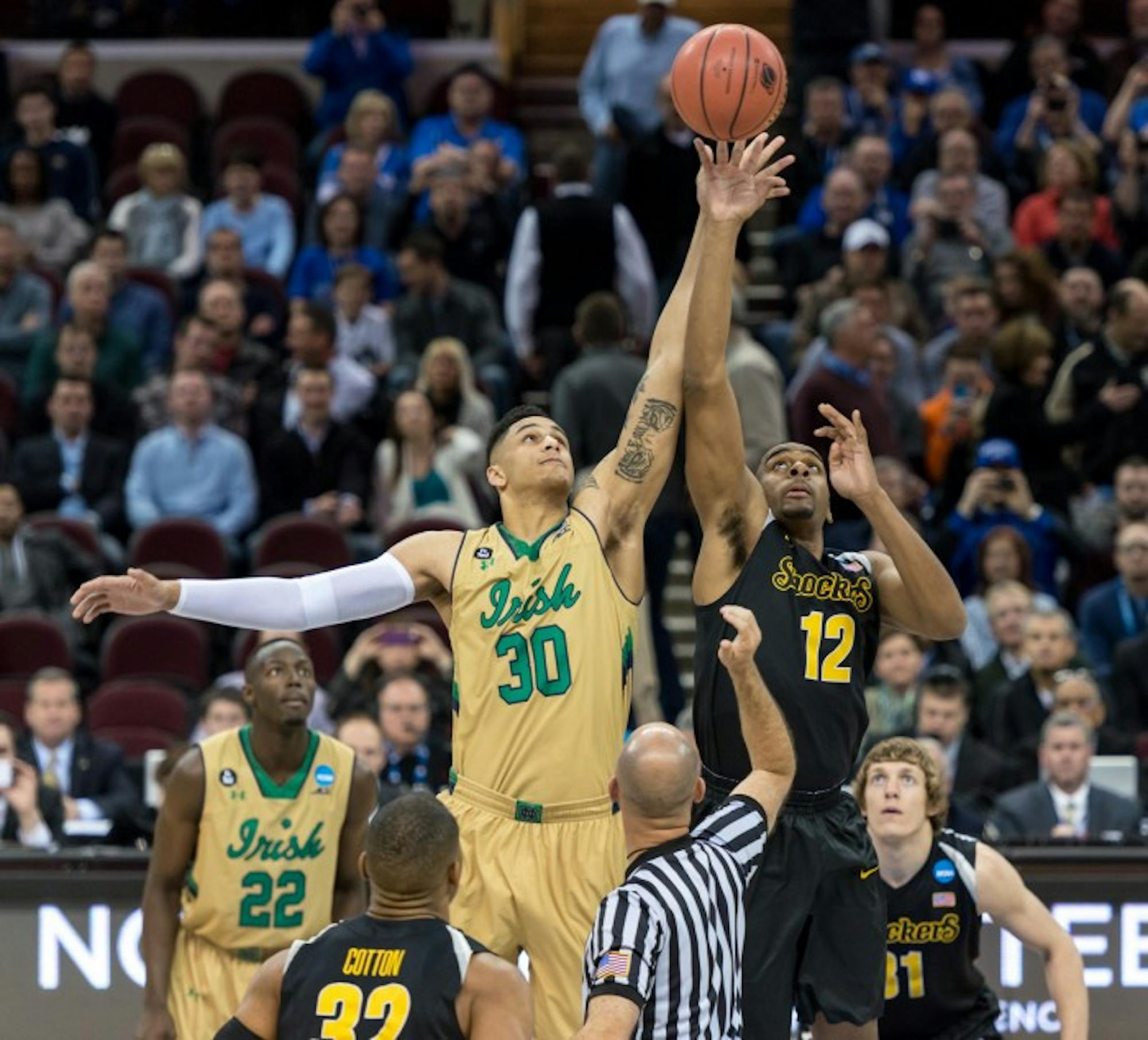 Irish senior forward Zach Auguste reaches for the tip-off at the start of a 81-70 victory against Wichita State on March 26 in Cleveland, OH.  Auguste had 15 points and six rebounds in the game.