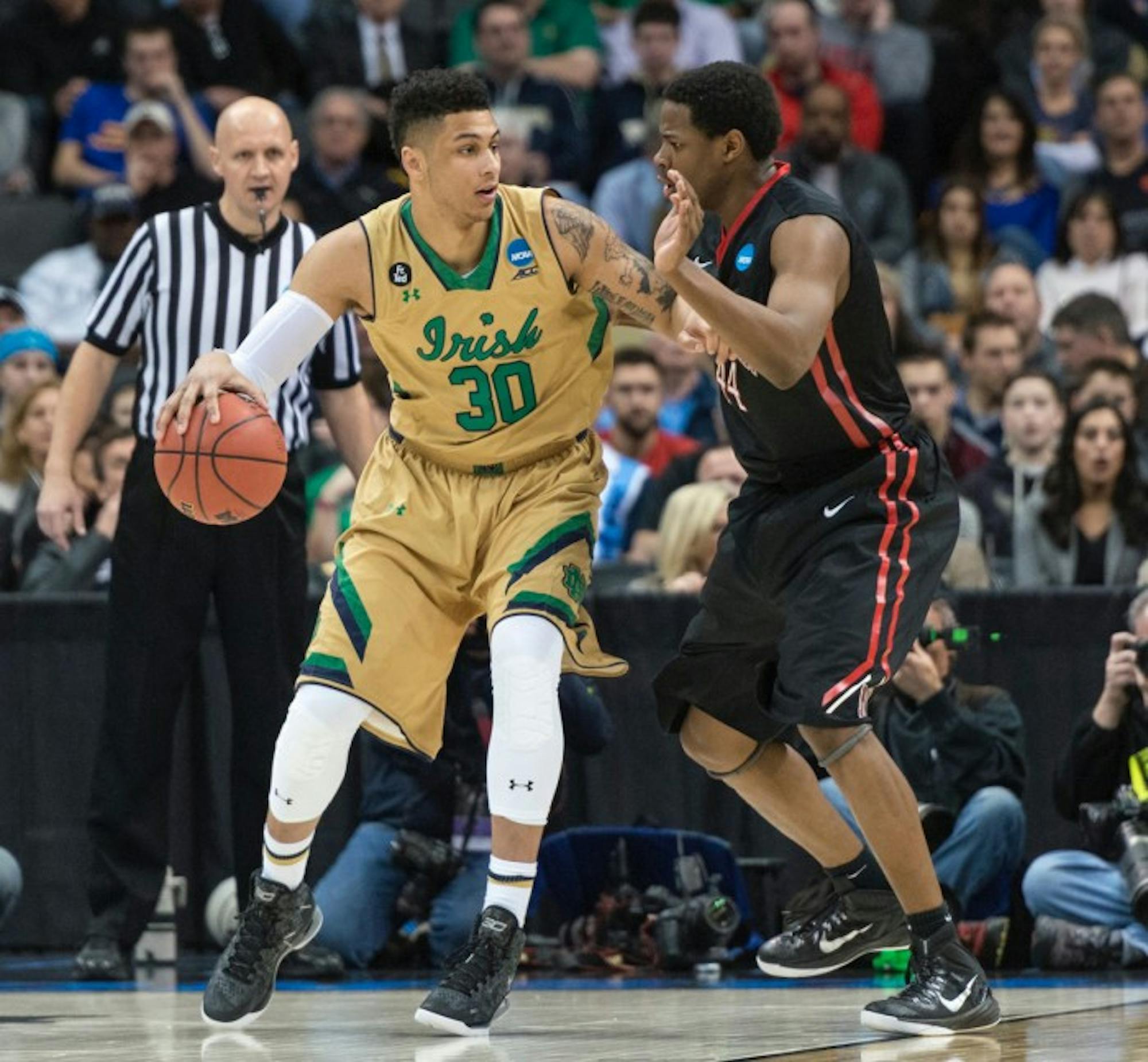 Irish junior forward Zach Auguste dribbles into the post against a defender during Notre Dame’s 69-65 win over Northeastern at CONSOL Energy Center in Pittsburgh on Thursday.