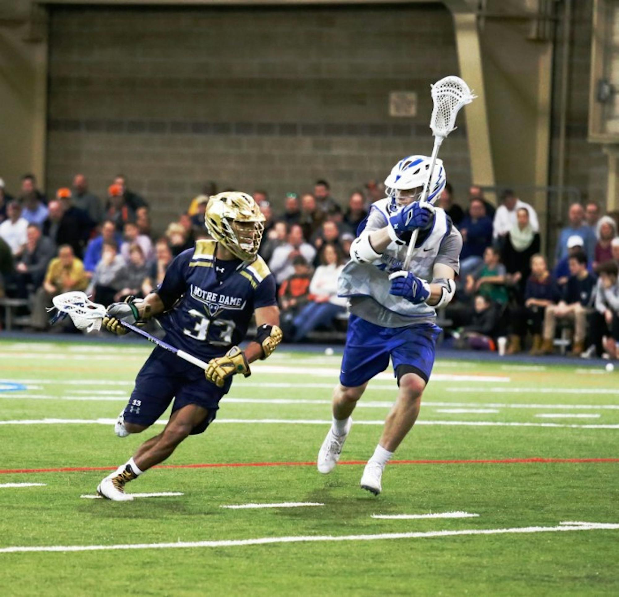 Irish sophomore midfielder Pierre Byrne looks towards the crease during Notre Dame’s scrimmage against Air Force on Jan. 30 at Loftus Sports Center. Byrne scored two goals in eight games last season.