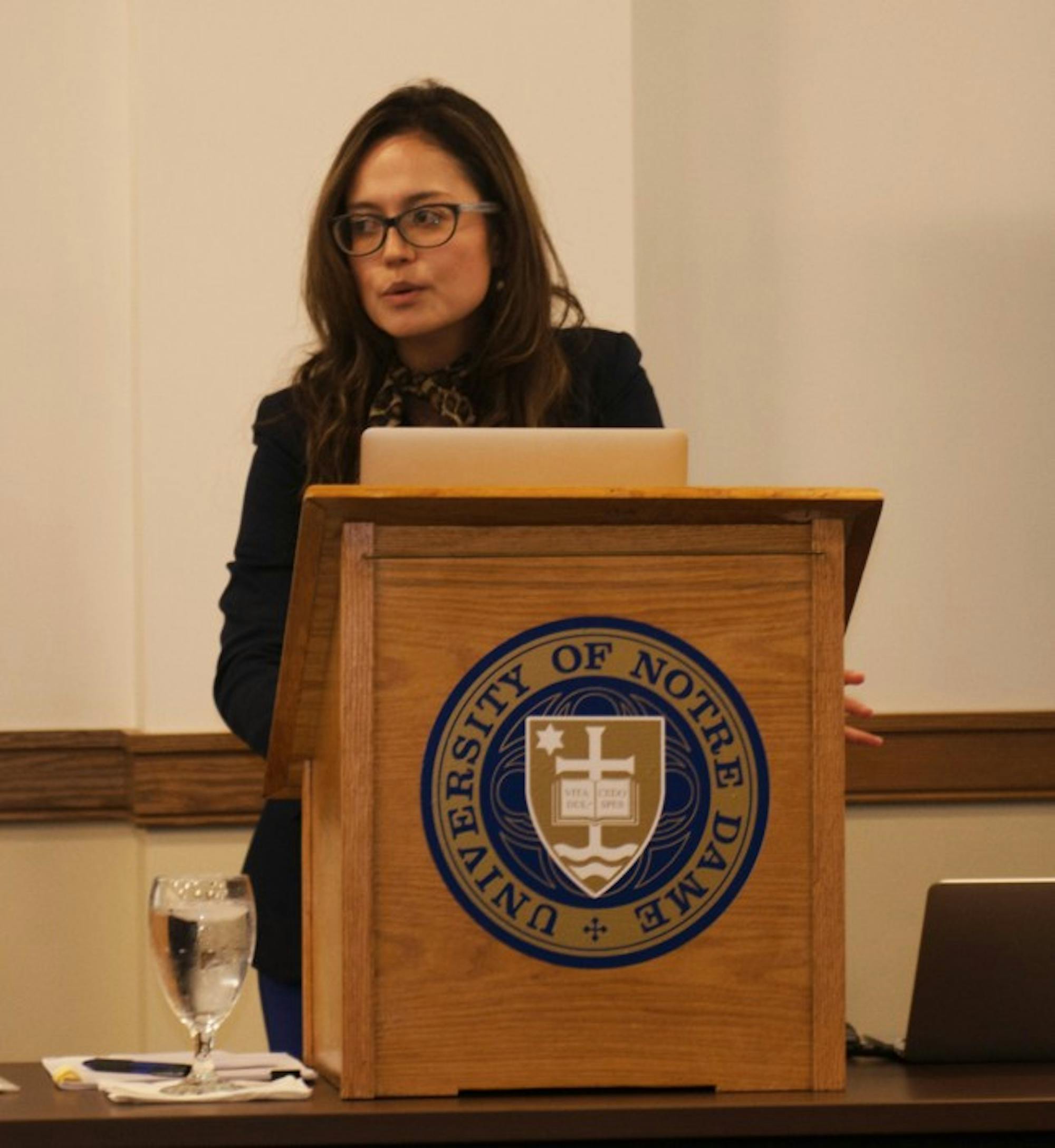 Thana Cristina de Campos, adjunct professor law at the University of Ottawa, lectures about ethical issues facing the pharmaceutical industry in the wake of the global health crisis Wednesday in Nanovic Hall.