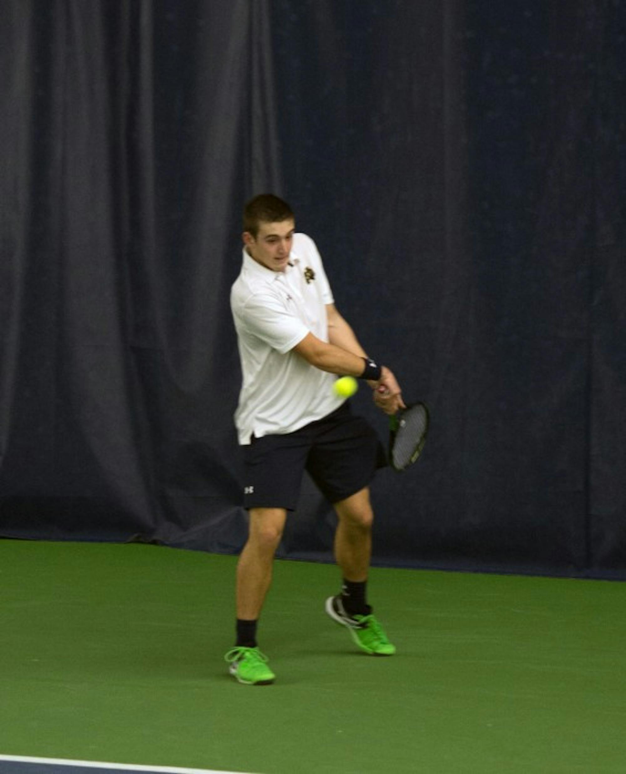 Irish freshman Nathan Griffin steps into a backhand during Notre Dame’s 7-0 win over Ball State on Feb. 7 at Eck Tennis Pavilion.