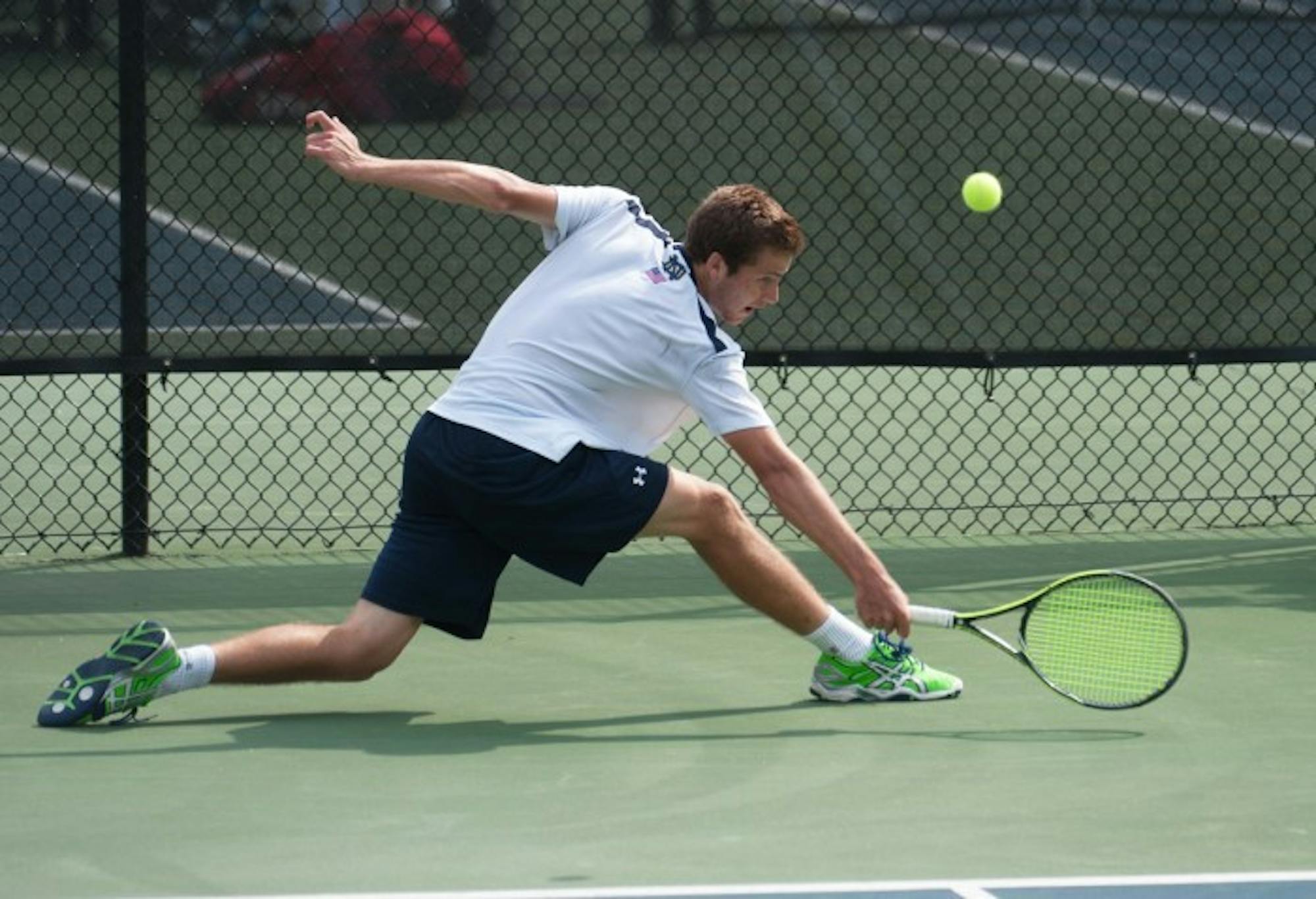 Irish senior Quentin Monaghan stretches out for a backhand shot during a match against North Carolina State on April 18 at Eck Tennis Pavilion. The Irish won the match 4-3.