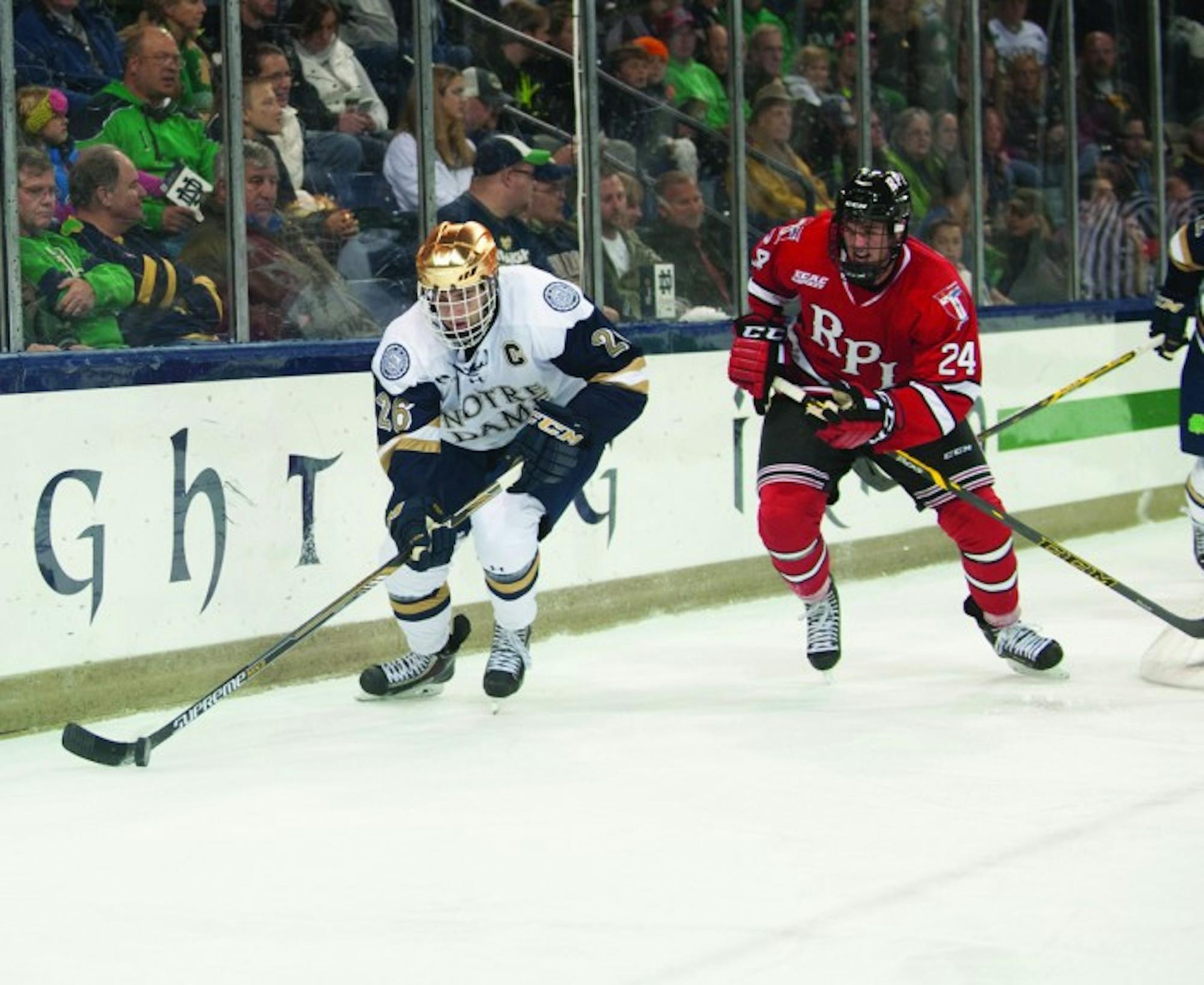 Irish junior center Steven Fogarty powers past a Rensselaer  defender during Notre Dame’s 3-2 loss to the Engineers on Oct 10.