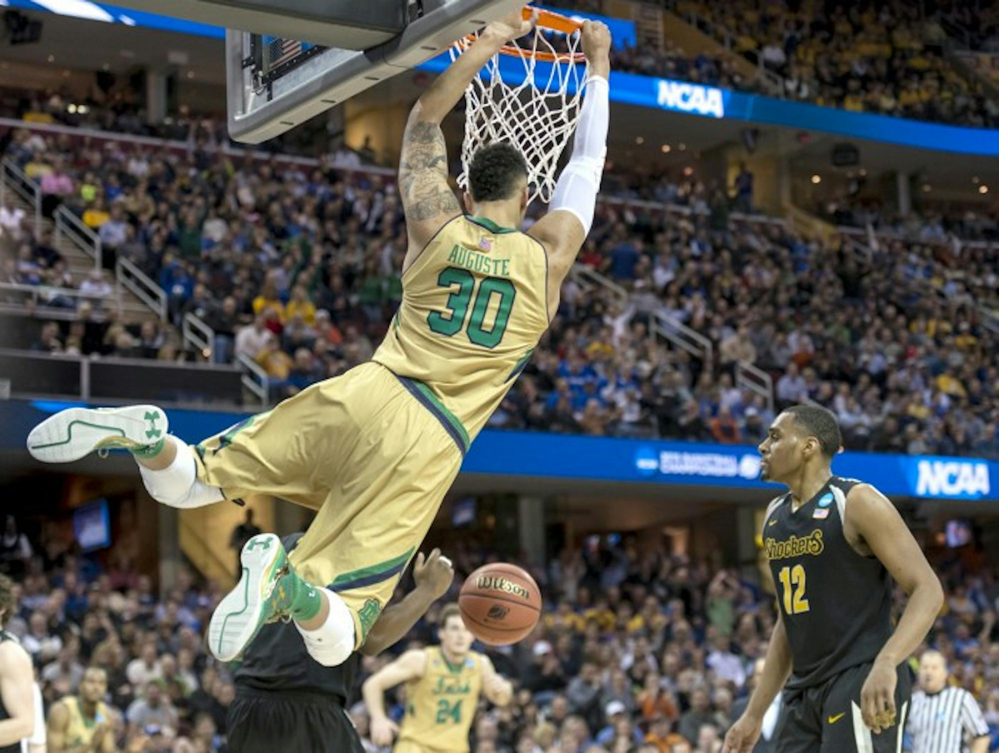 Irish junior forward Zach Auguste swings on the rim after dunking for two of his 15 points during Notre Dame’s 81-70 win over Wichita State in their Sweet 16 game. Auguste also pulled down six rebounds.
