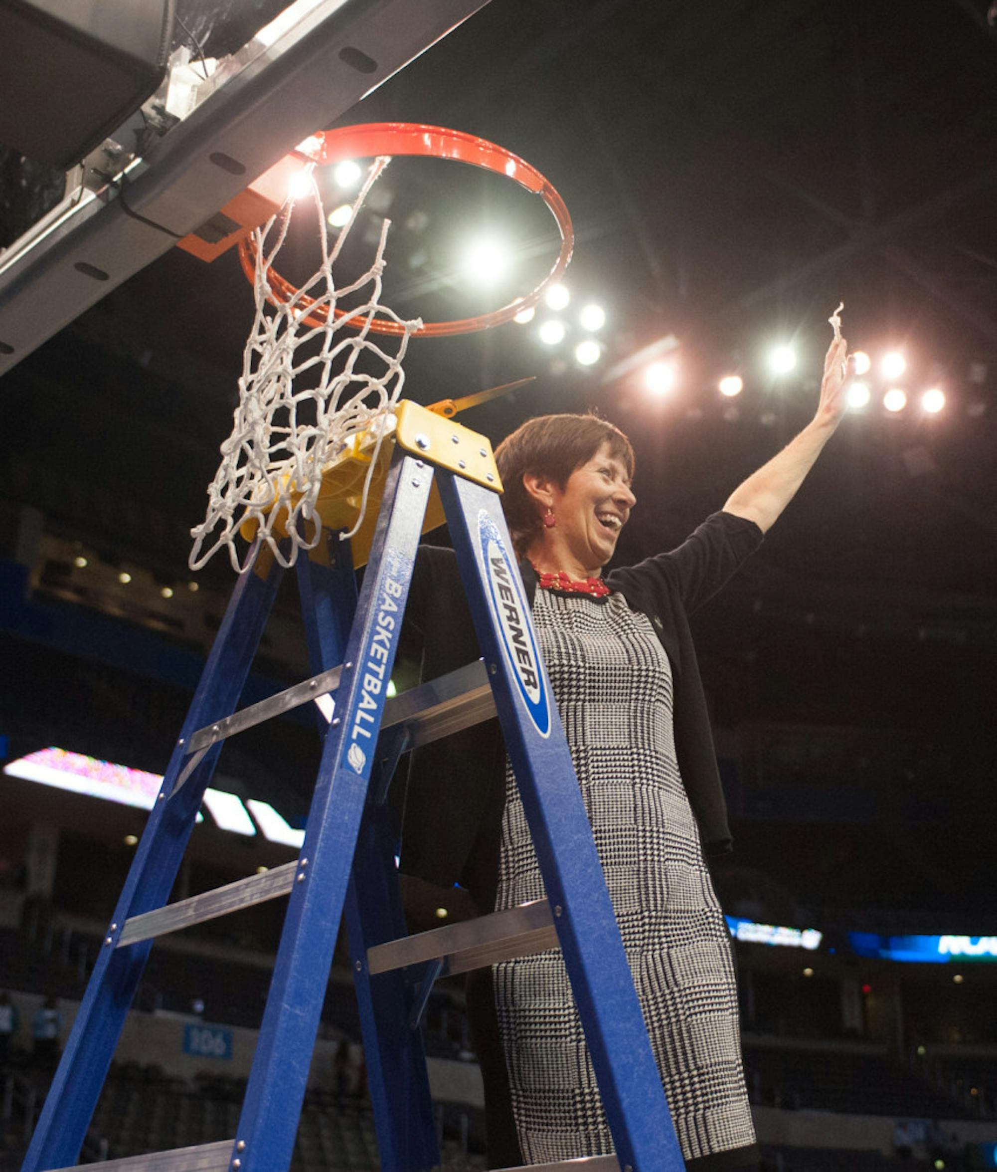 Irish head coach Muffet McGraw cuts down the net after her team defeated Baylor 77-68 in the Elite Eight on March 29, 2015 at Chesapeake Energy Arena in Oklahoma City. McGraw has 853 career wins.