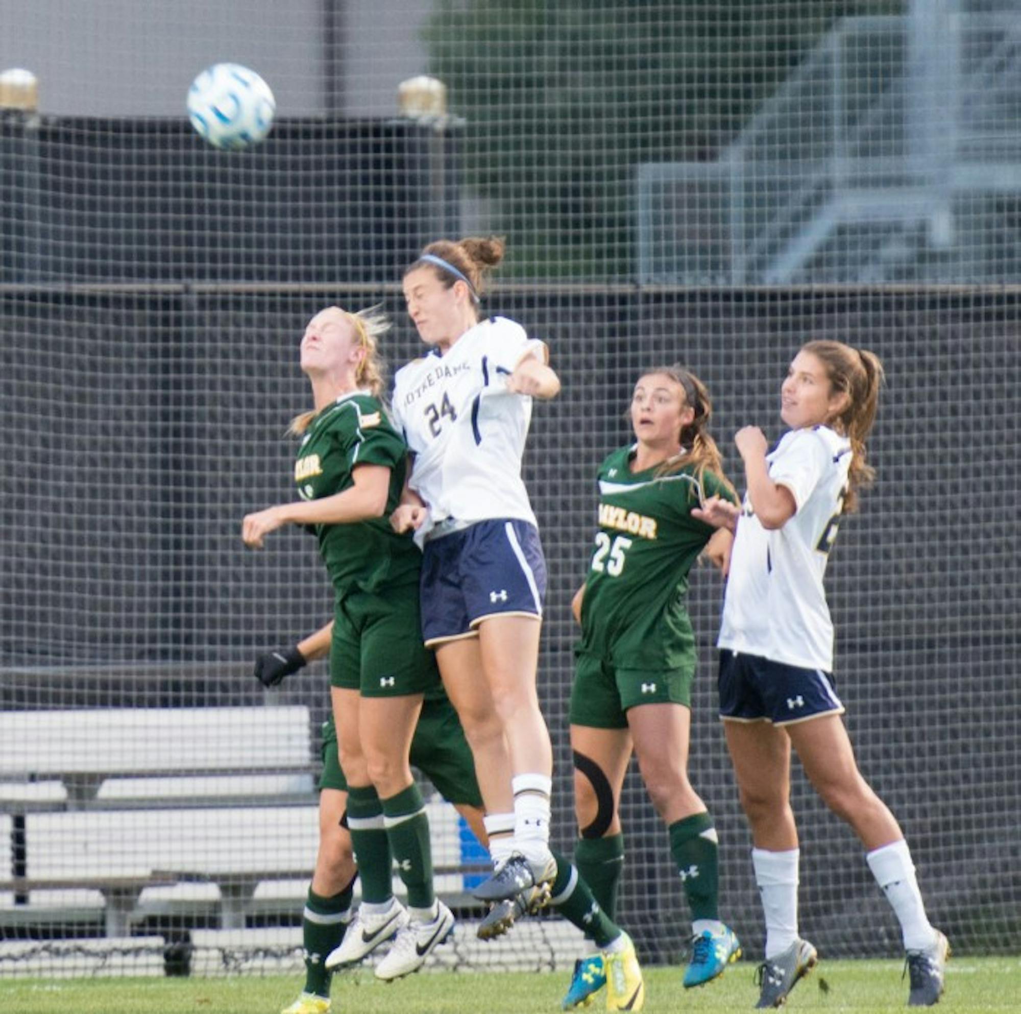 Irish junior defender Katie Naughton heads a shot over the defender during Notre Dame’s 1-0 victory over Baylor on Friday.