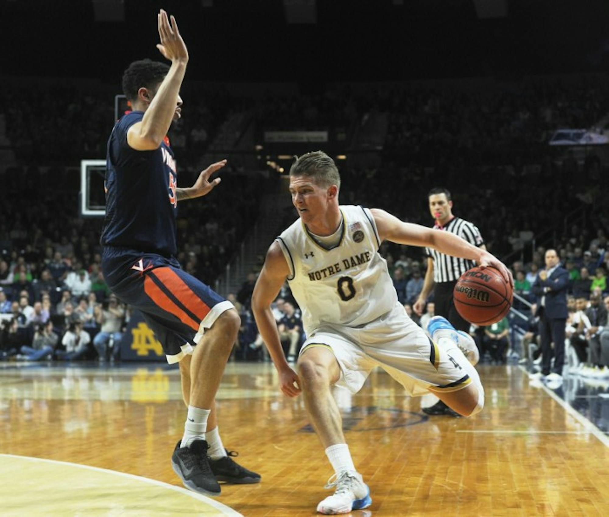 Irish sophomore Rex Pflueger drives towards the baseline during Notre Dame’s 71-54 loss to Virginia on Tuesday at Purcell Pavilion.