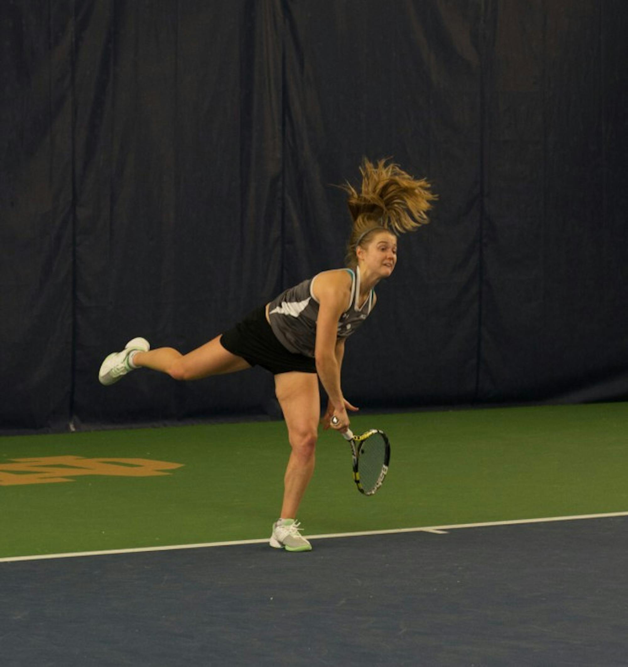 Irish senior Monica Robinson follows through on a serve during Notre Dame’s 6-1 victory over Indiana on Feb. 20 at Eck Tennis Pavilion.
