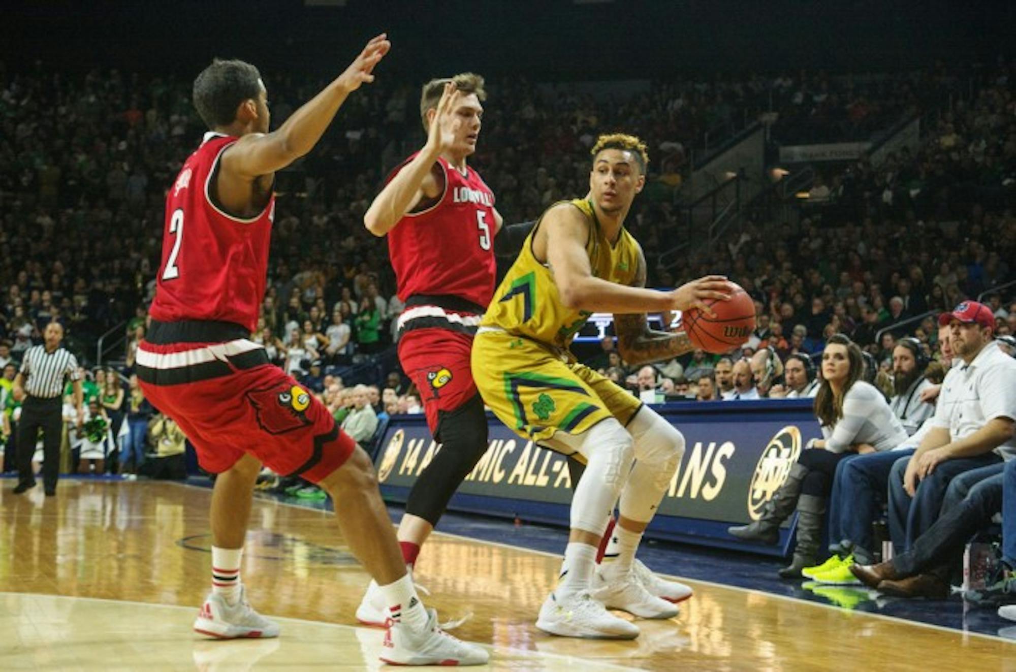 Irish senior forward Zach Auguste looks for an open teammate during Notre Dame’s 71-66 win over Louisville on Feb. 13 at Purcell Pavilion. Auguste is questionable for Wednesday with a knee injury.
