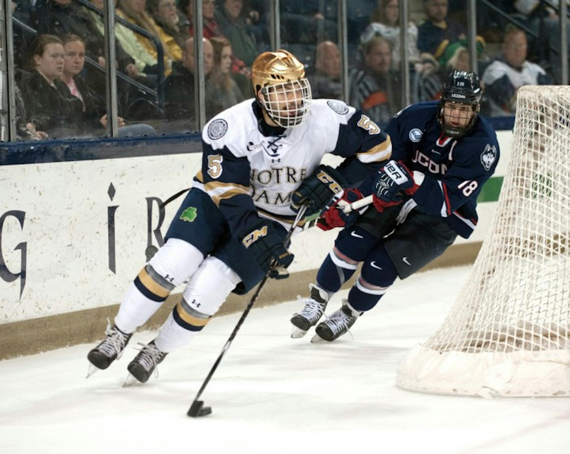 Irish senior defenseman Robbie Russo circles the net Jan. 16 against UConn at Compton Family Ice Arena. The two teams tied, 3-3.