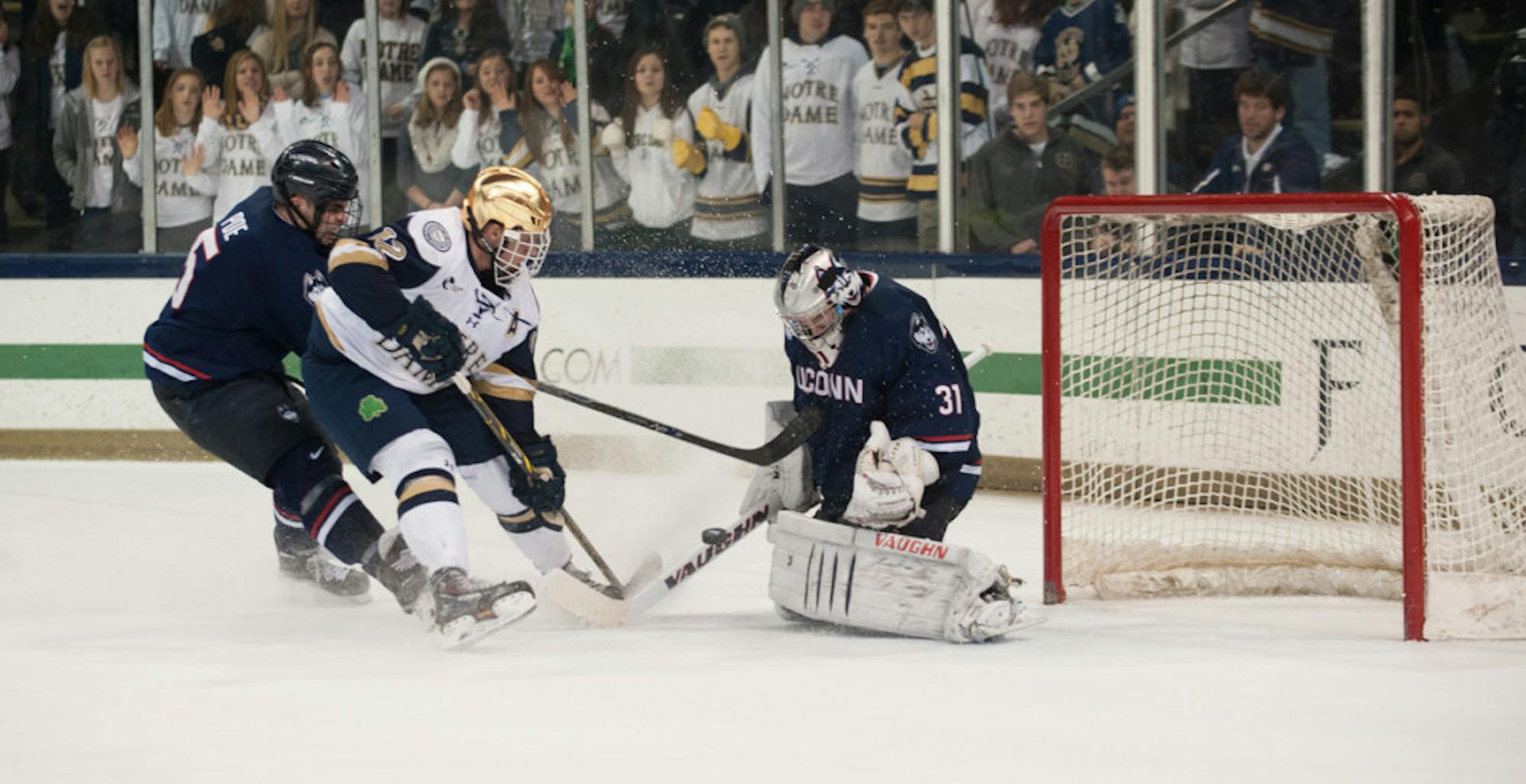 Irish junior left wing and alternate captain Sam Herr fires a shot towards UConn sophomore goaltender Rob Nichols during Friday’s 3-3 tie between the Irish and the Huskies at Compton Family Ice Arena.