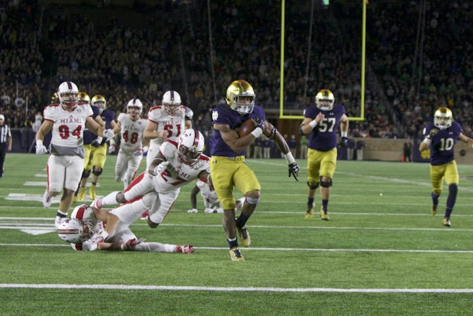 Irish sophomore running back Deon McIntosh slips past a defender during a 26-yard touchdown run in Notre Dame's 52-17 win over Miami (OH) on Saturday.