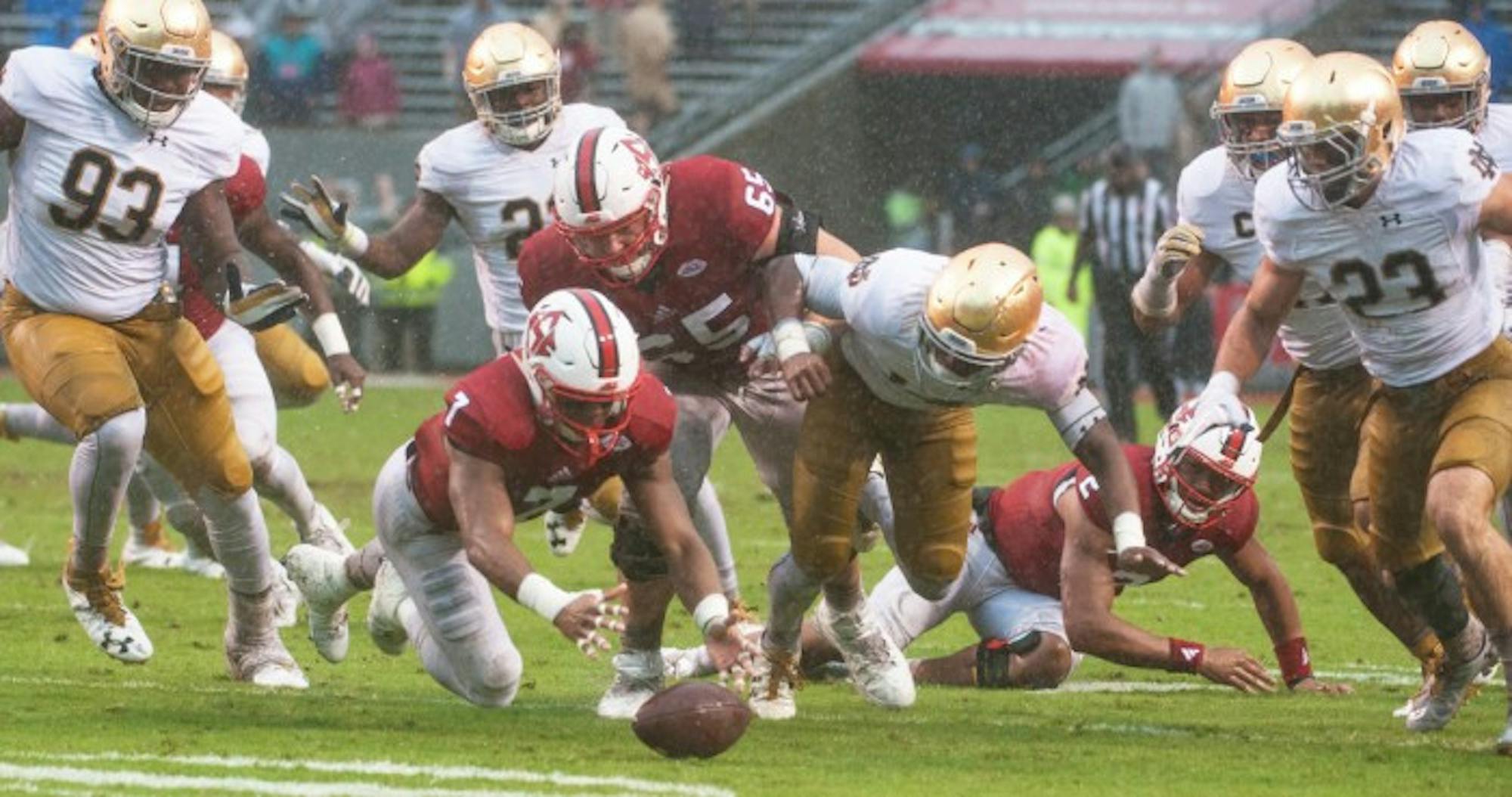 Notre Dame plays dive for a loose ball during Saturday's 10-3 loss to North Carolina State at Carter-Finley Stadium.