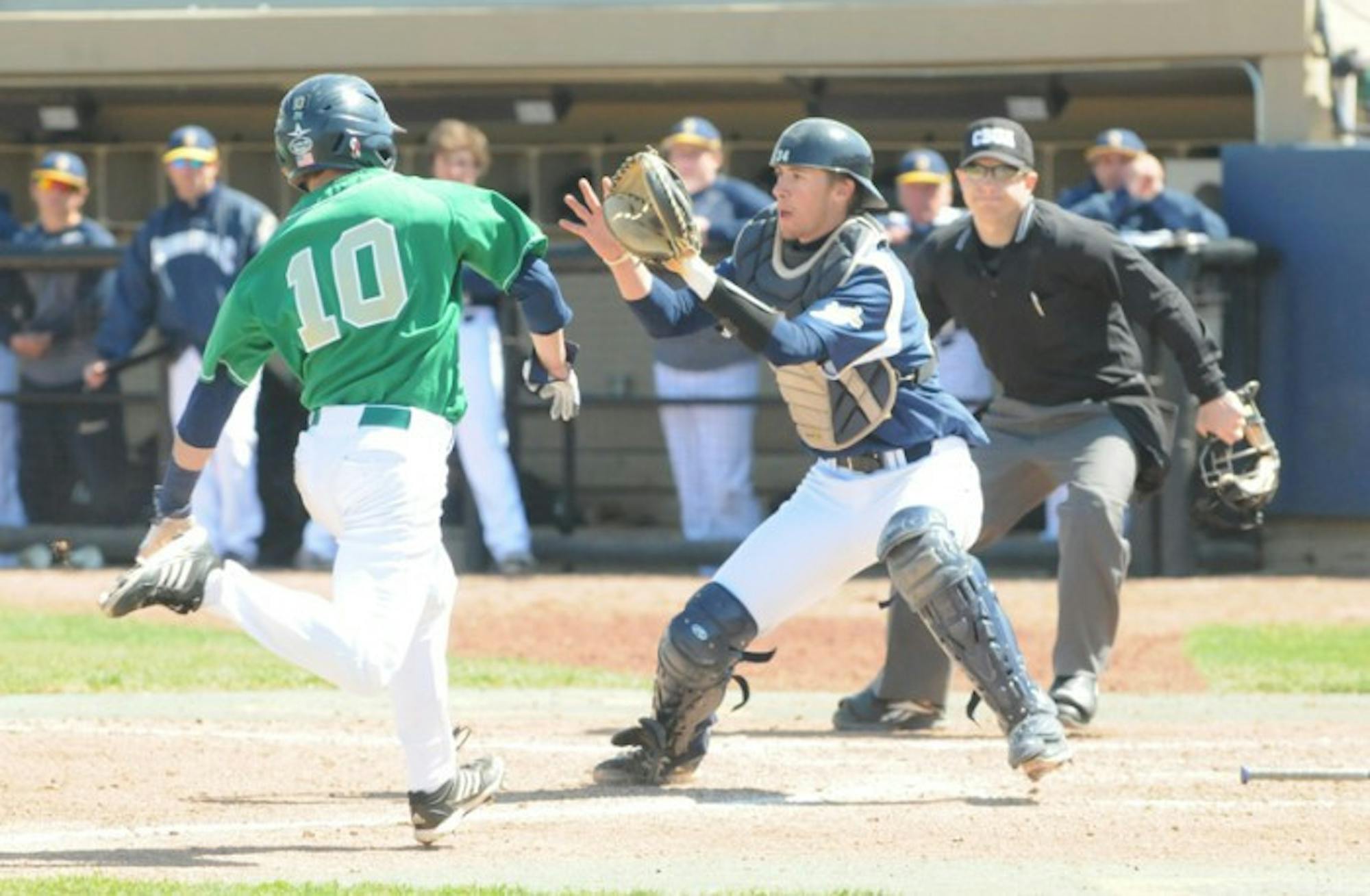 Irish junior outfielder Conor Biggio attempts a hook slide around Quinnipiac junior catcher Steffen Herter during Notre Dame's 5-1 win on April 21. Last season, Biggio hit .263 for the Irish. Though playing primarily as a bench player, Biggio also finished fourth on the team in stolen bases, finishing with four in 2013.