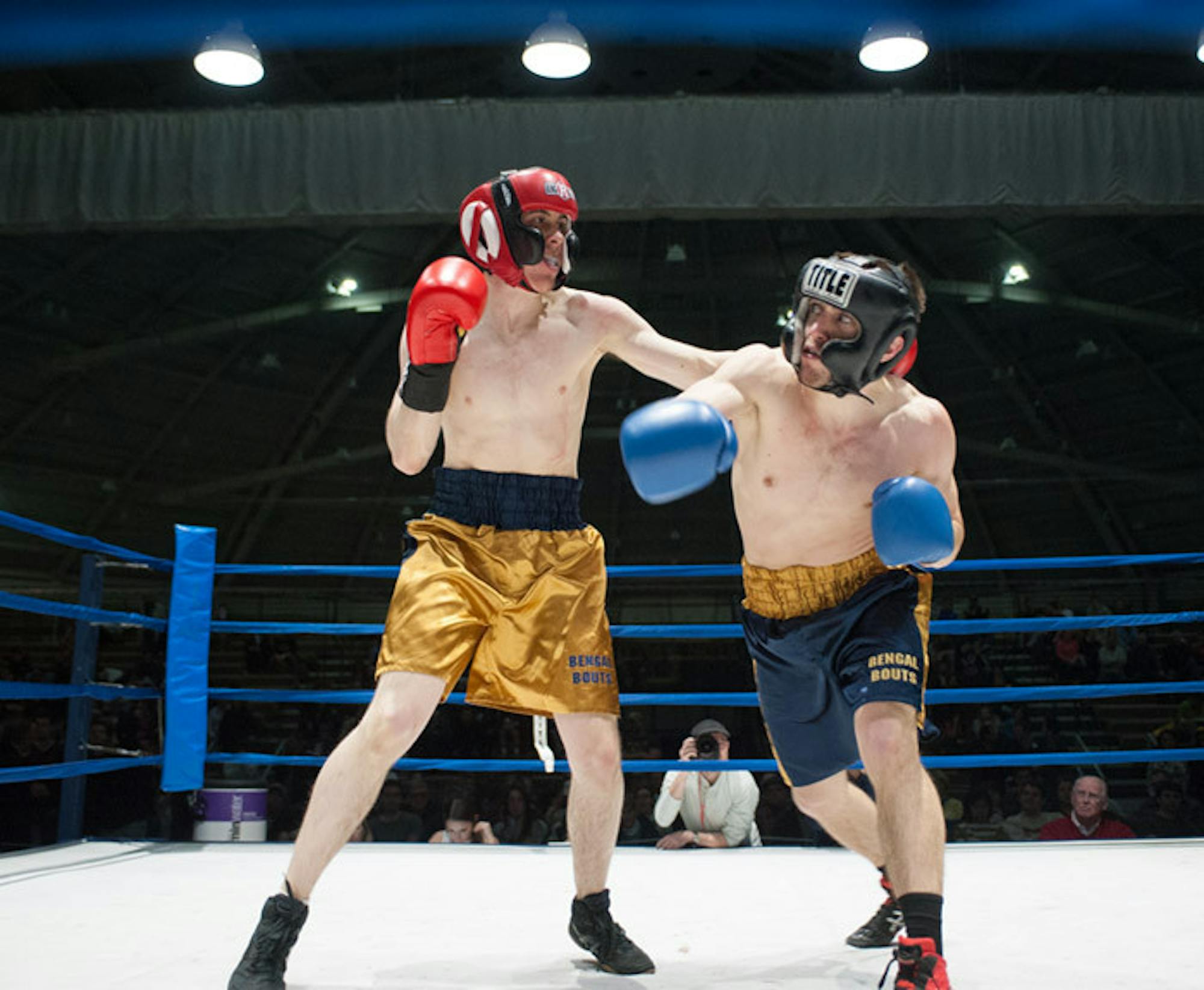 Senior captain Ben Eichler, right, dodges a big swing from sophomore Ryan Dunn during their semifinal bout Tuesday night. Eichler emerged victorious by a split decision.