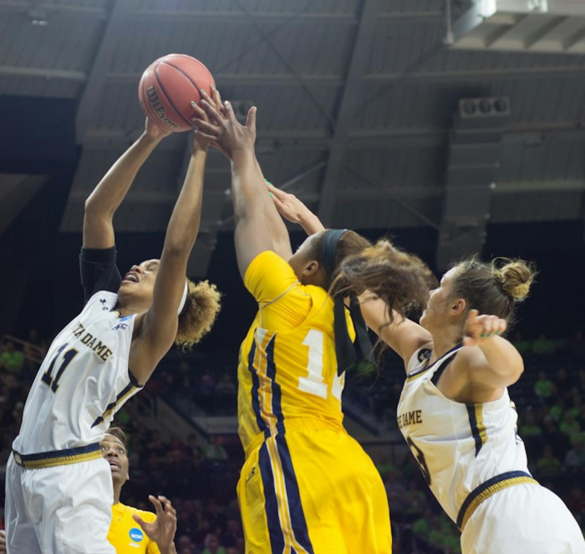 Irish sophomore forward Brianna Turner snags a rebound away from a North Carolina A&T player while Irish freshman guard Marina Mabrey looks on during Notre Dame's 95-61 victory Saturday at Purcell Pavilion in the first round of the NCAA tournament.
