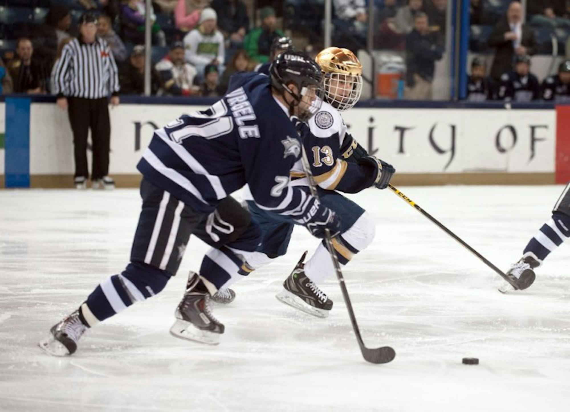 Irish sophomore center Vince Hinostroza battles for the puck during Notre Dame’s 5-2 loss to New Hampshire on Friday.