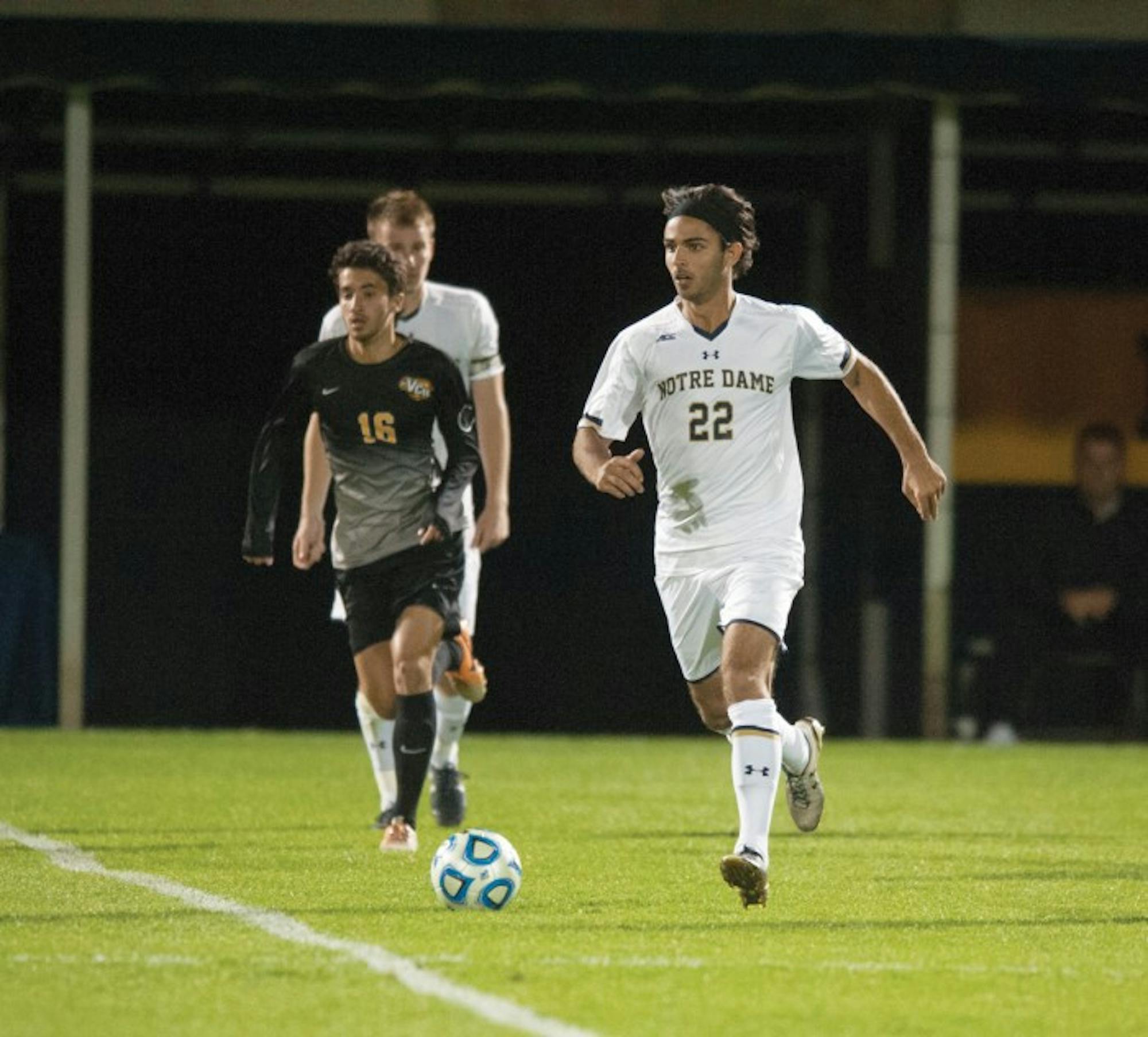 Irish senior defender Luke Mishu sprints to the ball during Notre Dame’s 1-0 win against VCU on Tuesday at Alumni Stadium.