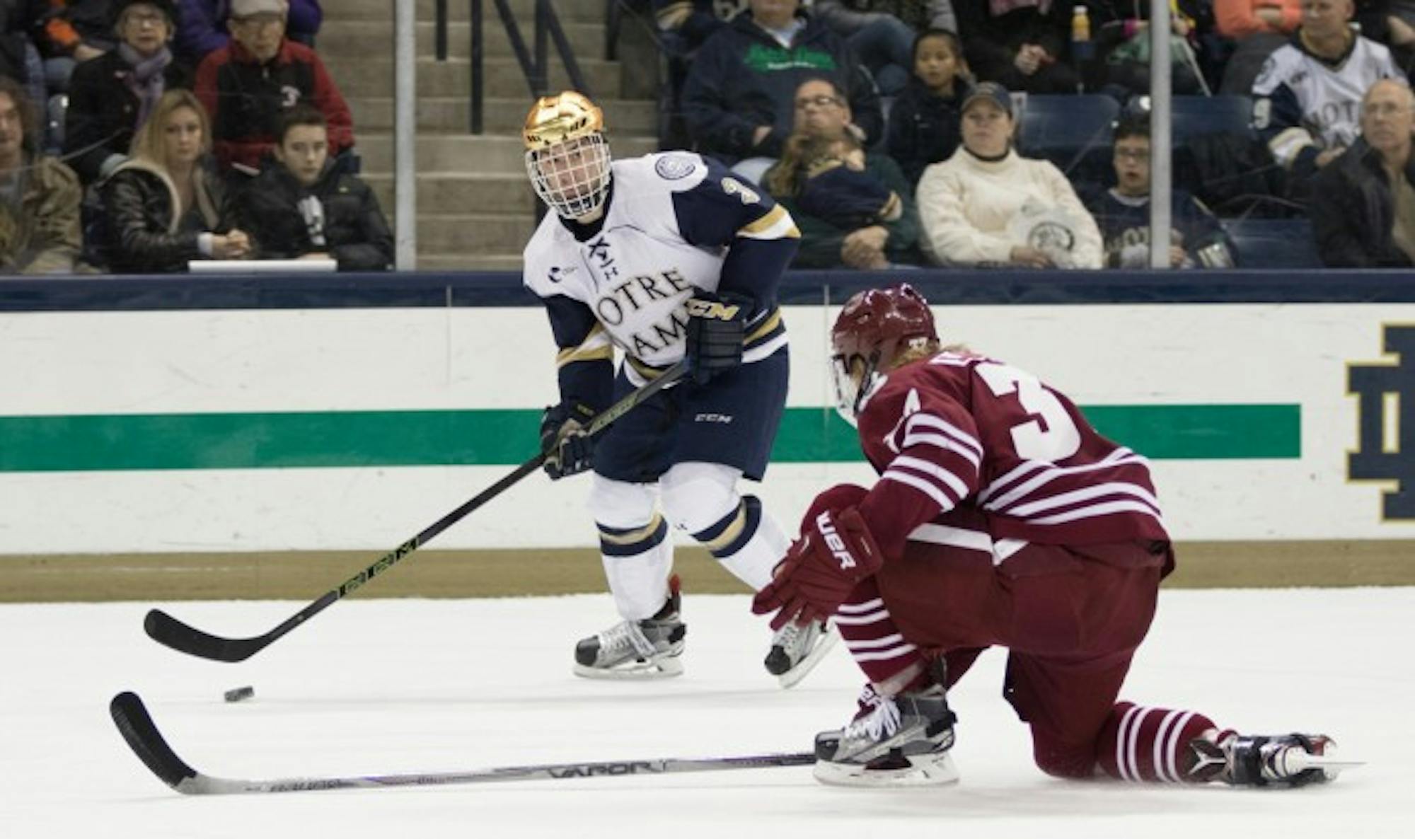 Sophomore defenseman Jordan Gross looks to make a pass during Notre Dame’s 5-1 victory over Massachusetts on Dec. 5. Gross was named the Hockey East Defensive Player of the Week for his four-point performance during the weekend series against Vermont.