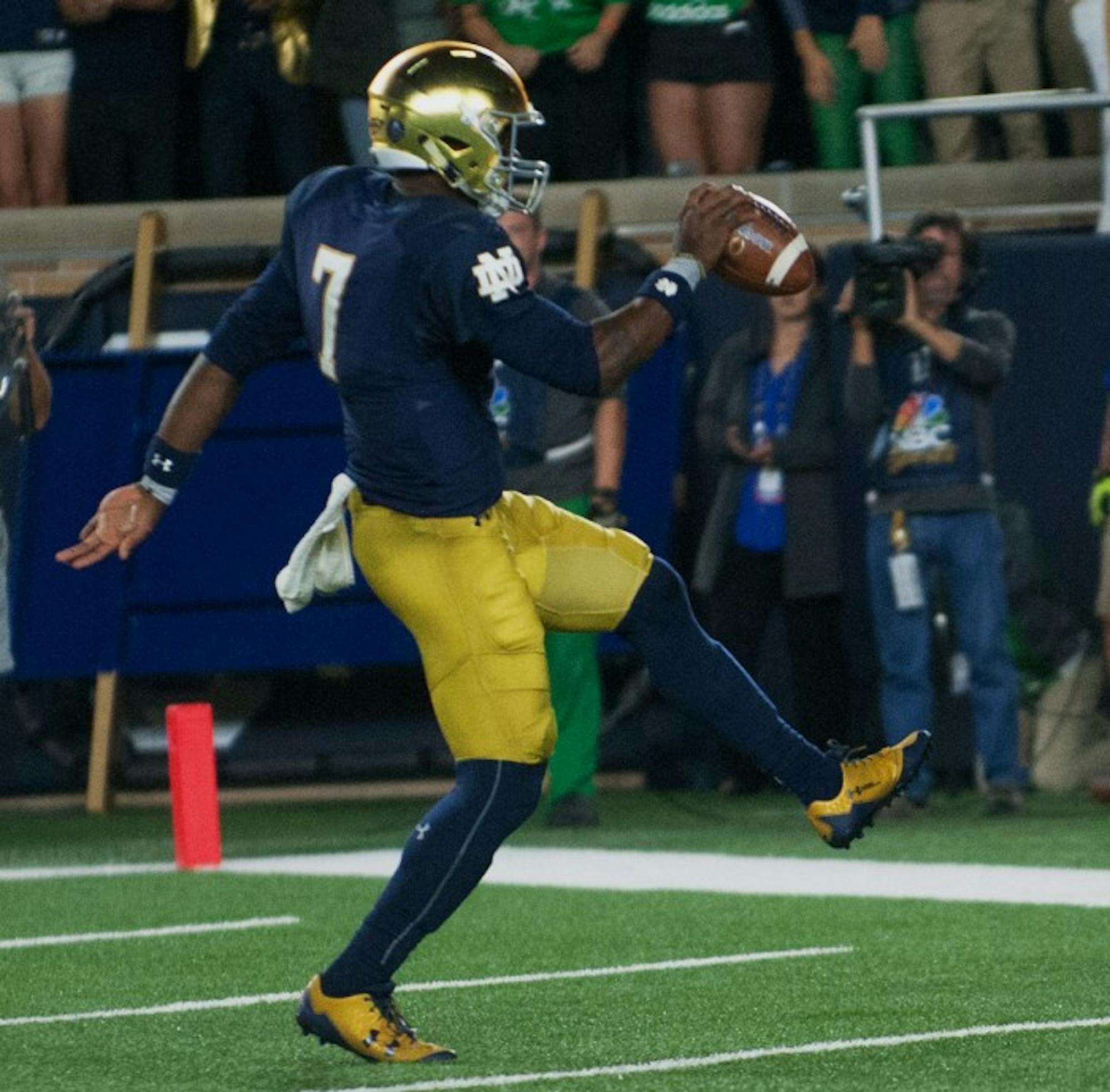 Irish junior quarterback Brandon Wimbush scampers into the endzone after a touchdown run during Notre Dame's 49-14 win over USC on Saturday.