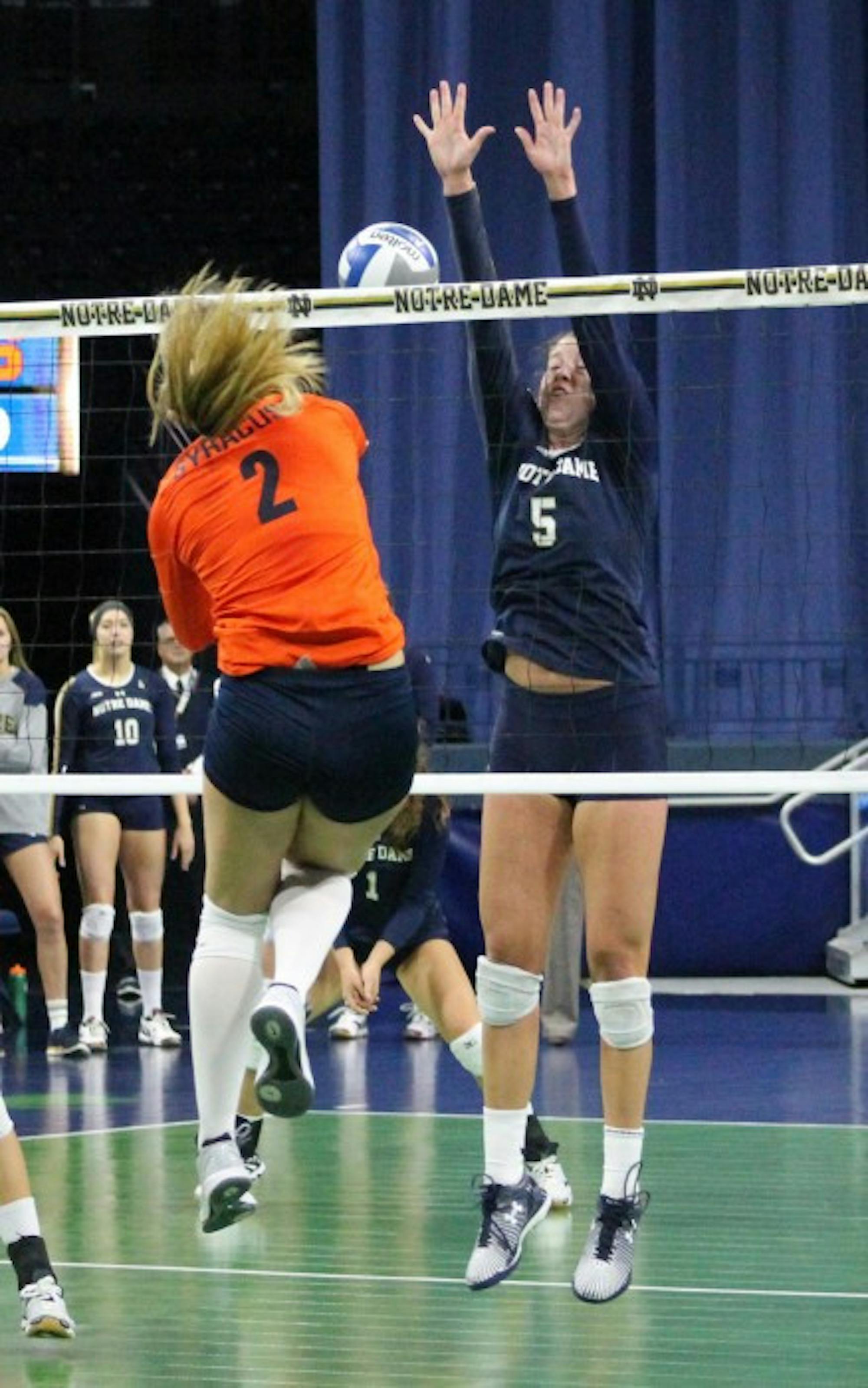 Sophomore outside hitter Sydney Kuhn jumps to block a hit during Notre Dame’s 3-2 loss to Syracuse on Sunday at Purcell Pavilion.