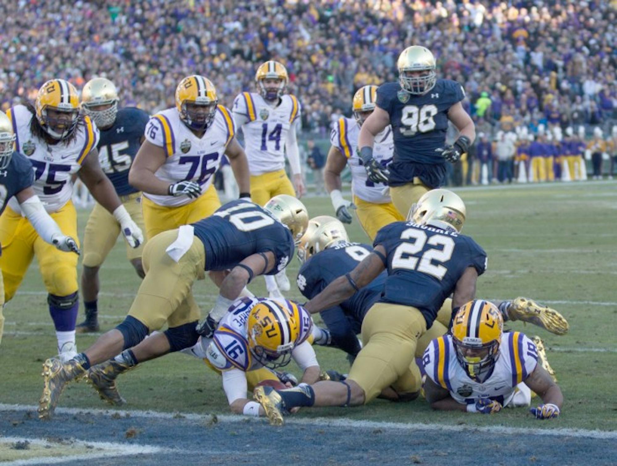 Irish safeties junior Max Redfield, 10, and senior Elijah Shumate, 22, tackle an LSU ballcarrier at the goal line during Notre Dame's 31-28 win in the Music City Bowl on Dec. 30.