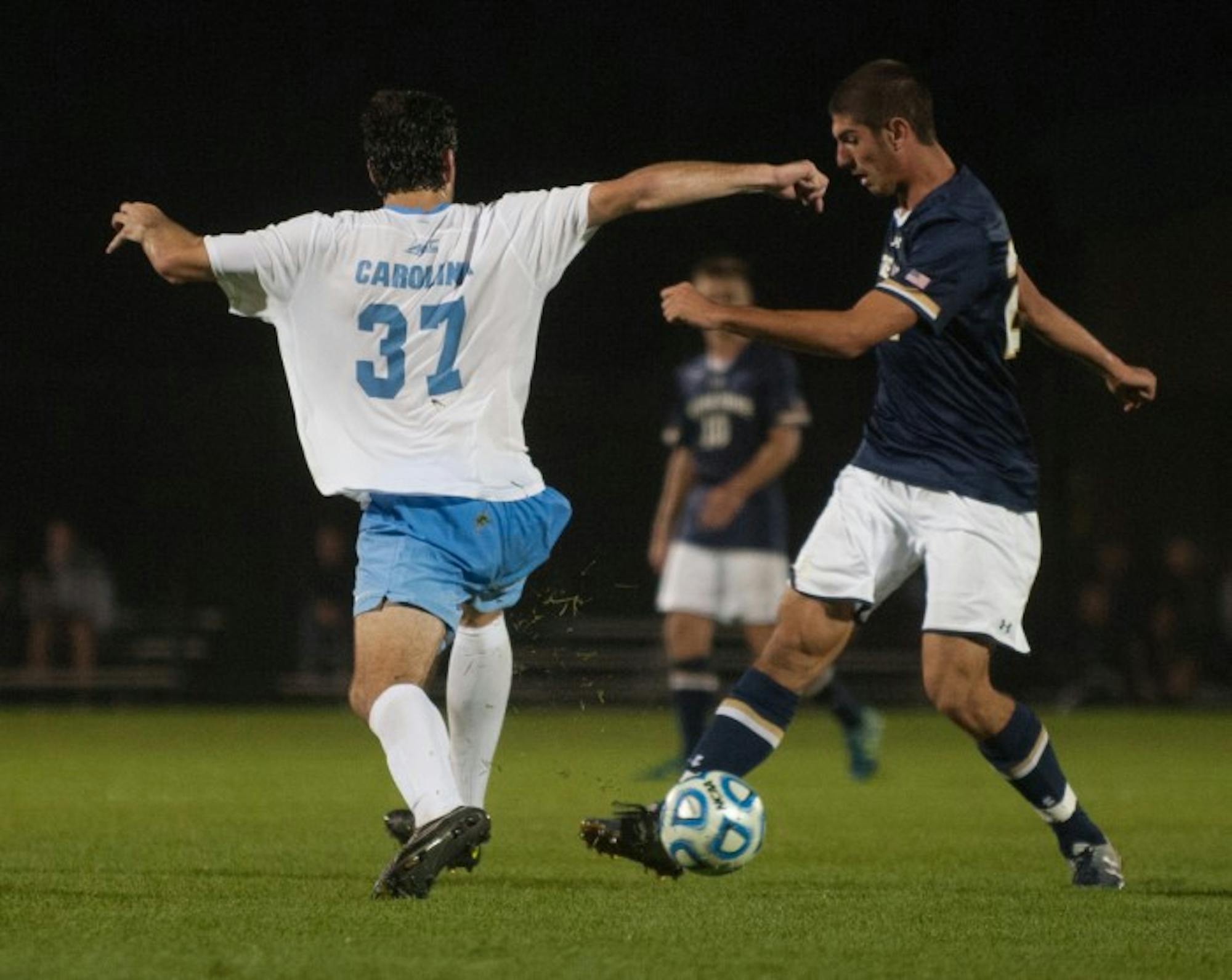 Irish freshman forward Jeffery Farina shields the ball as a North Carolina defender attempts to take it away during Notre Dame’s 2-0 victory over the Tar Heels on Friday at Alumni Stadium.