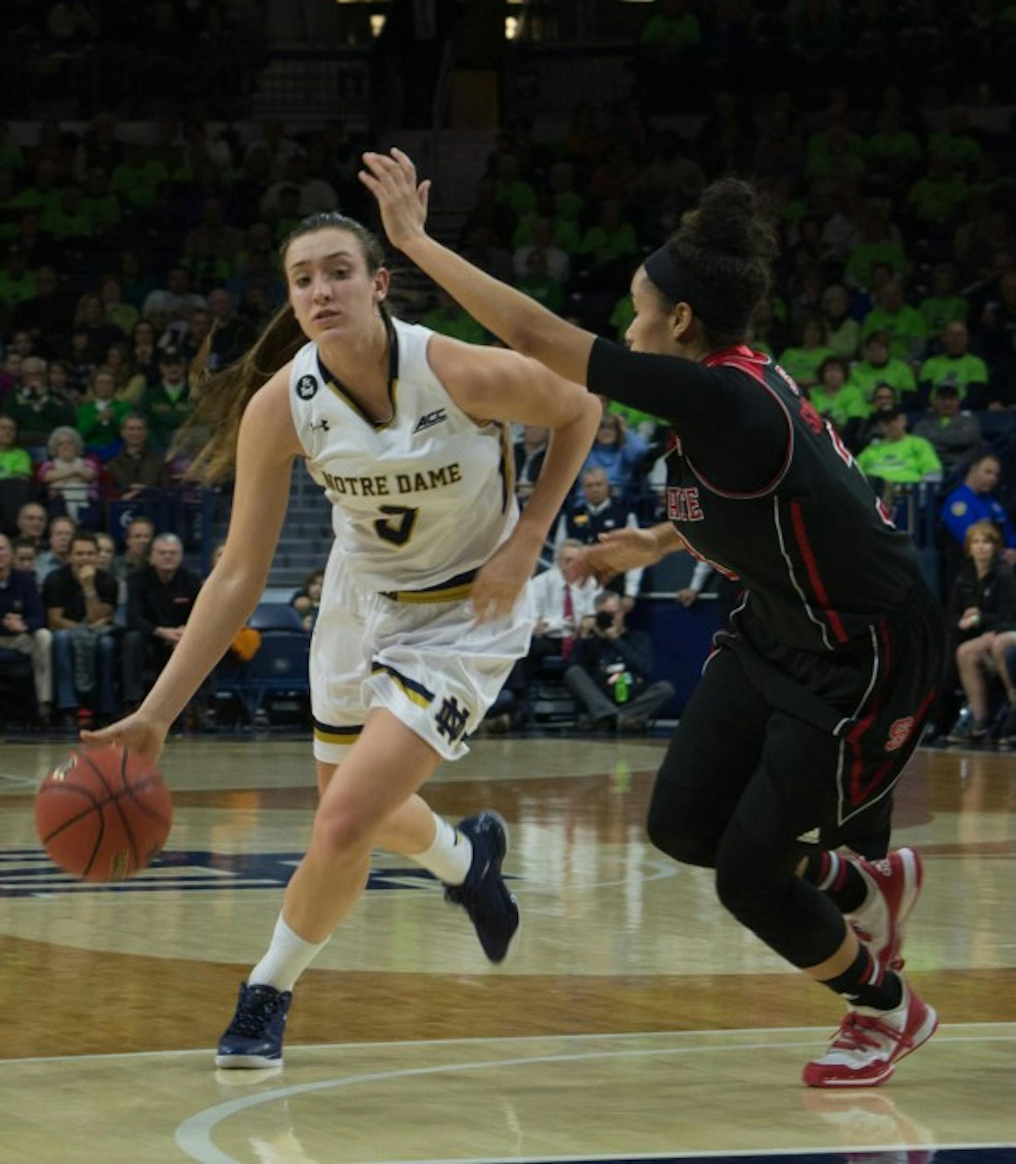 Freshman guard Marina Mabrey dribbles past a North Carolina State defender during Notre Dame’s 82-46 victory Feb. 4. The Irish will host conference foe Miami (Fla.) at Purcell Pavilion on Sunday.