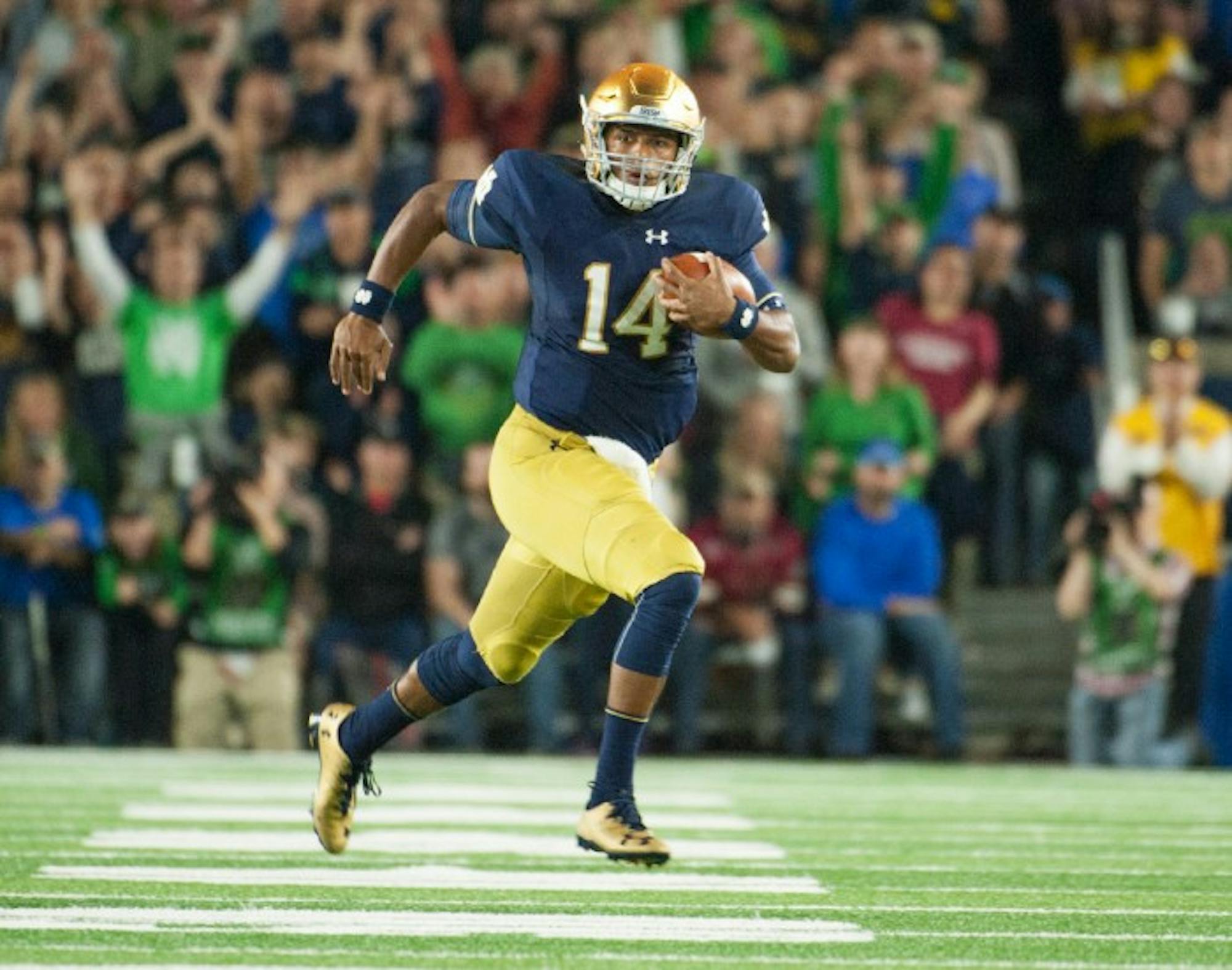 DeShone Kizer tucks the ball and takes off toward the sideline during Notre Dame’s loss to Stanford. Kizer finished the game with 154 yards on 14-for-26 passing. He added another 83 yards and a touchdown on 11 rushing attempts, including a 49-yard scamper.