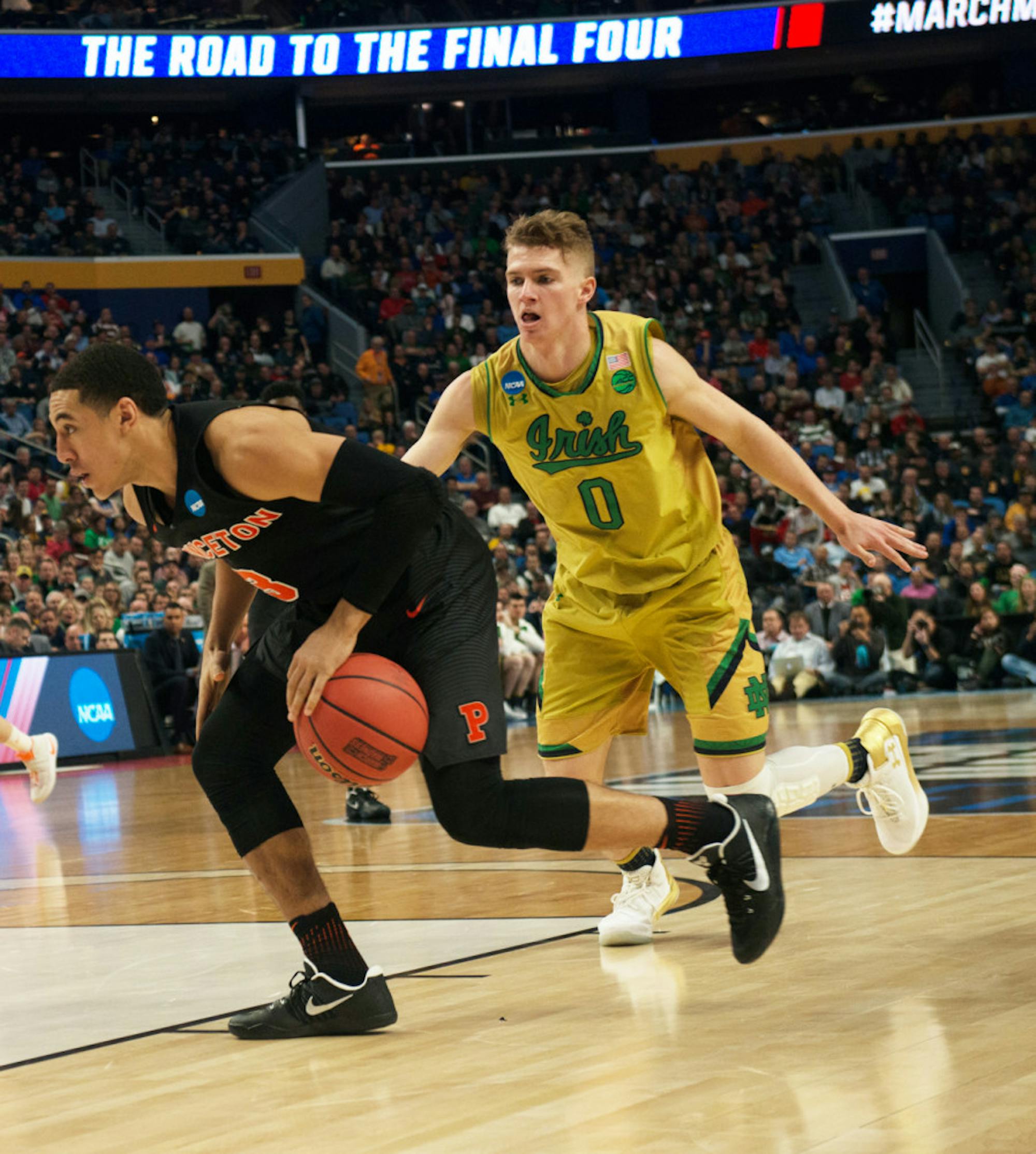 Irish junior guard Rex Pflueger chases Tigers junior guard Devin Cannady during Notre Dame’s 60-58 win in the first round of the NCAA tournament over Princeton at KeyBank Center on March 16.