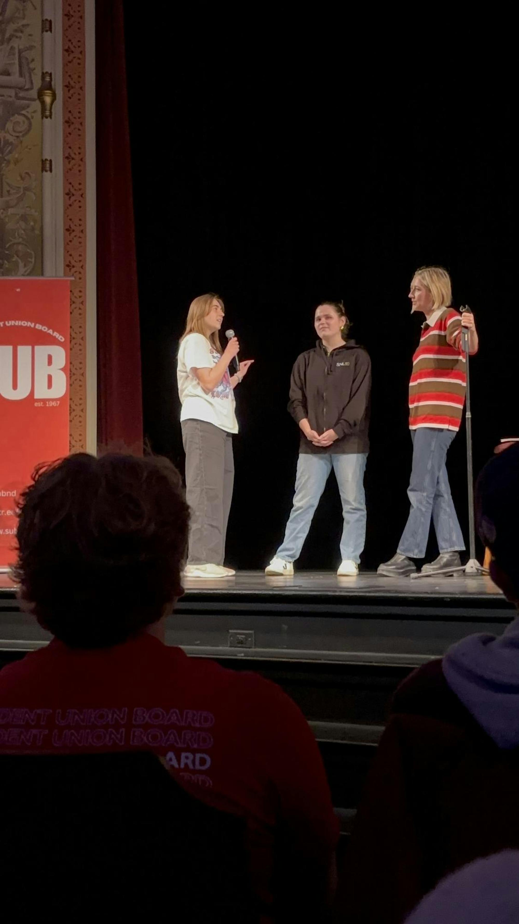 Students seen on stage as part of audience interaction segment.jpeg