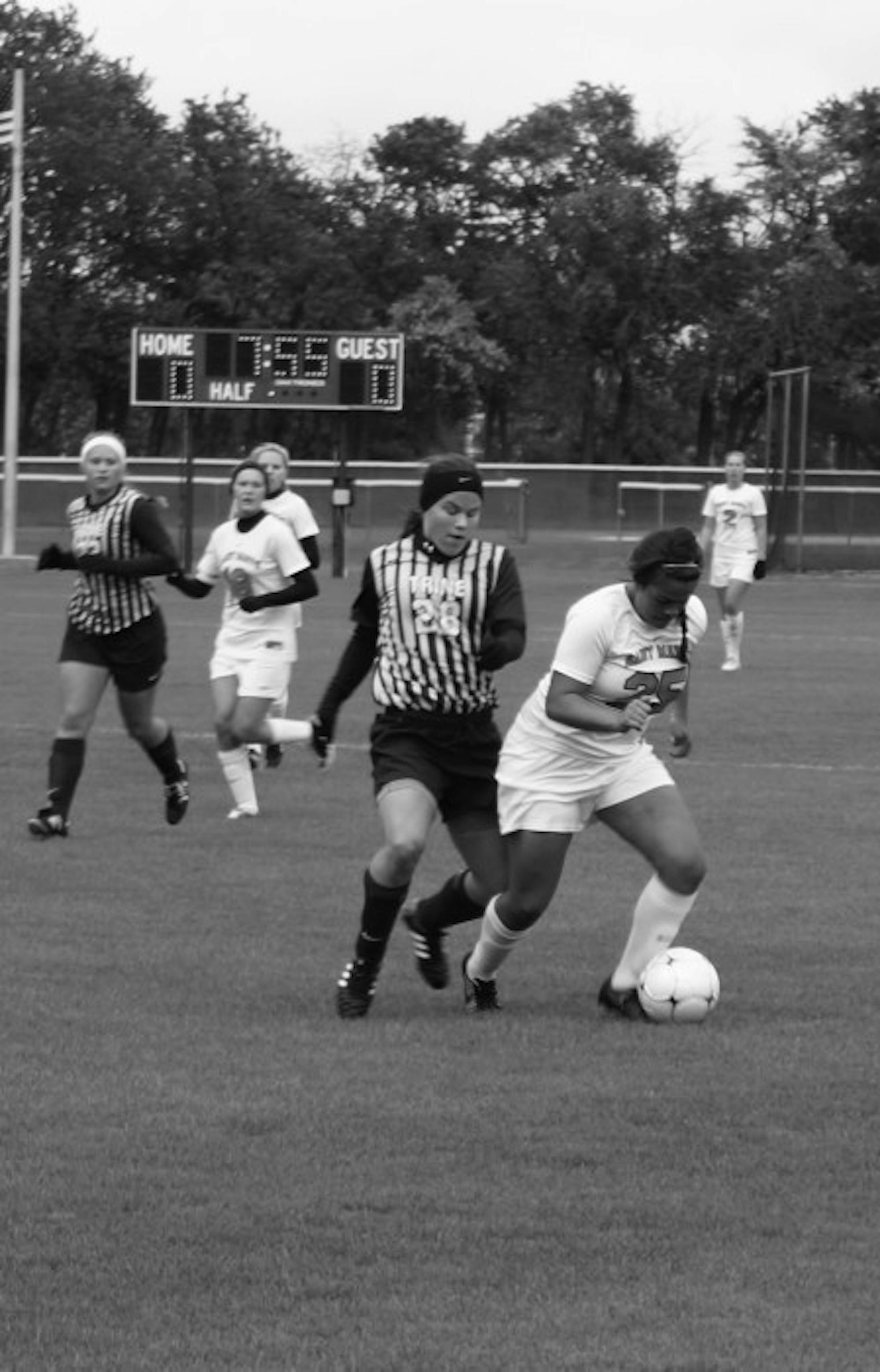 Belles sophomore forward Liza Felix holds off a Trine defender  during the Belles’ 1-0 home win over the Thunder on Oct. 4.