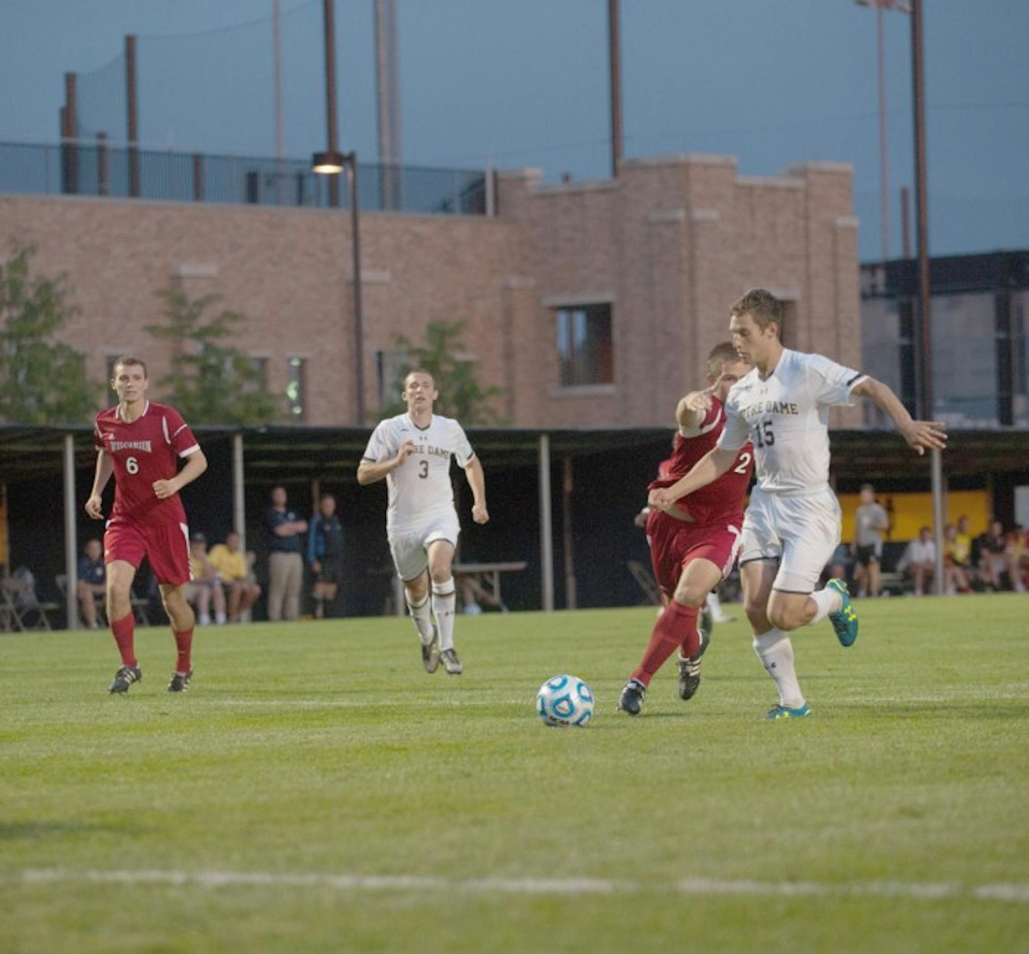 Irish junior midfielder Evan Panken charges past a Wisconsin defender for a look at the goal, while fellow junior midfielder Connor Klekota backs him up in Notre Dame’s 5-1 victory over Wisconsin on Aug. 25.